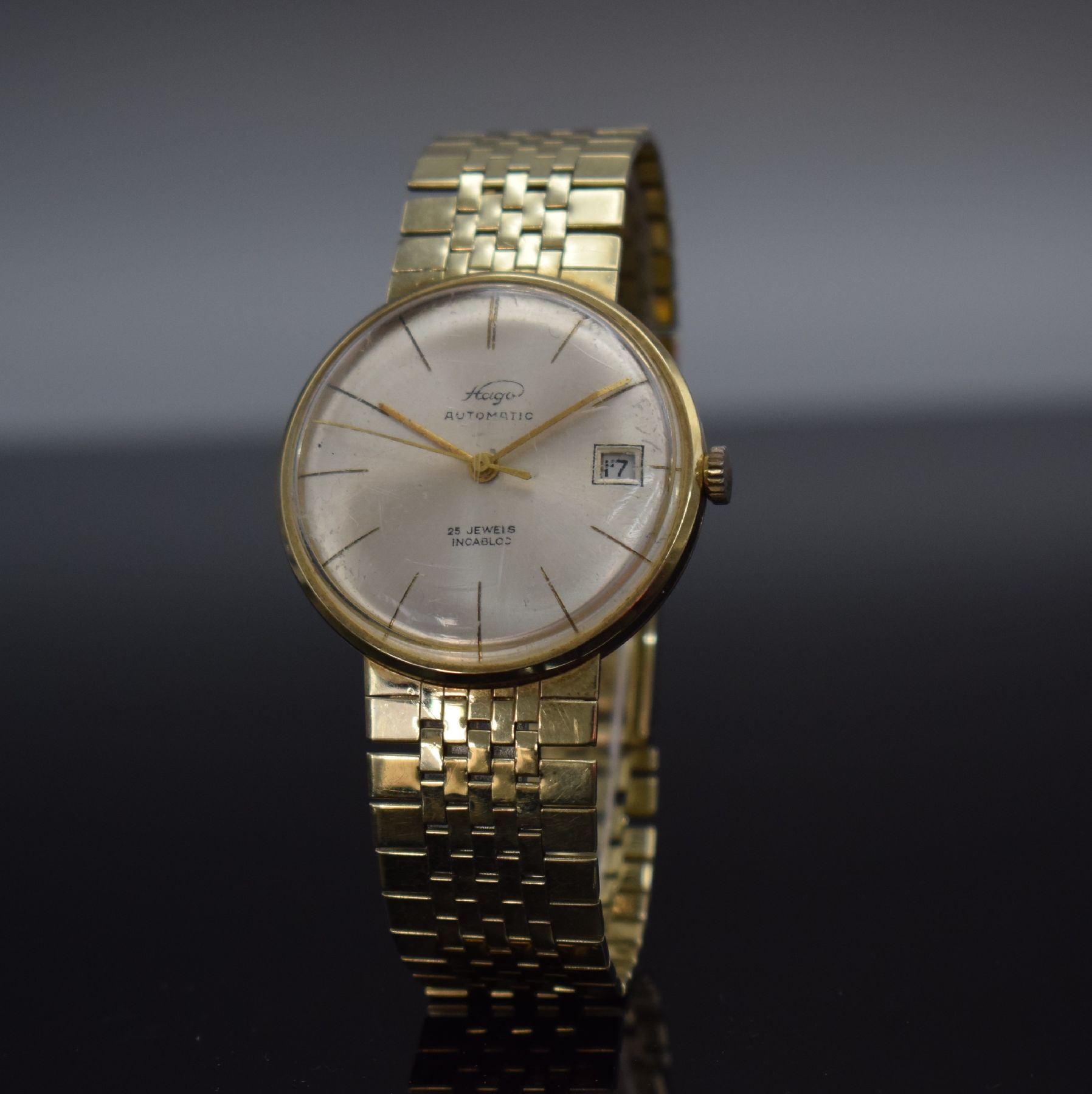 Detail b: HAGO Herrenarmbanduhr in GG 585/000, Deutschland/Schweiz um 1960, Automatik, aufgedr. Boden dell., anges. Goldband, silb. Zifferbl., gold. Zeiger, ...