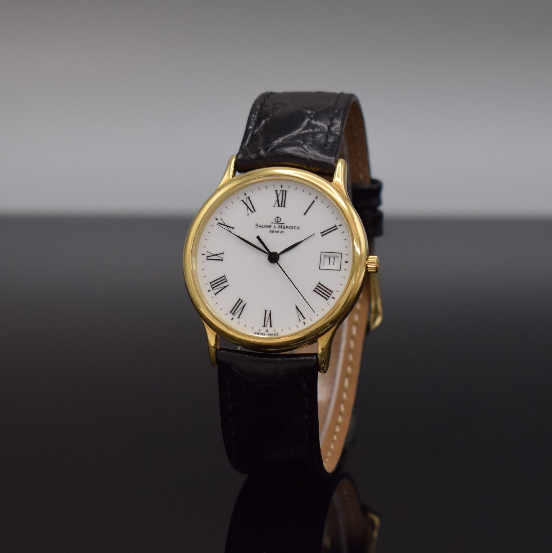 Detail b: BAUME & MERCIER Armbanduhr in GG 750/000, Schweiz um 1995, quarz, 2-teil. Geh., Boden aufgedr., weißes Zifferbl. m. röm. Zahlen, schwarze Zeiger, ...