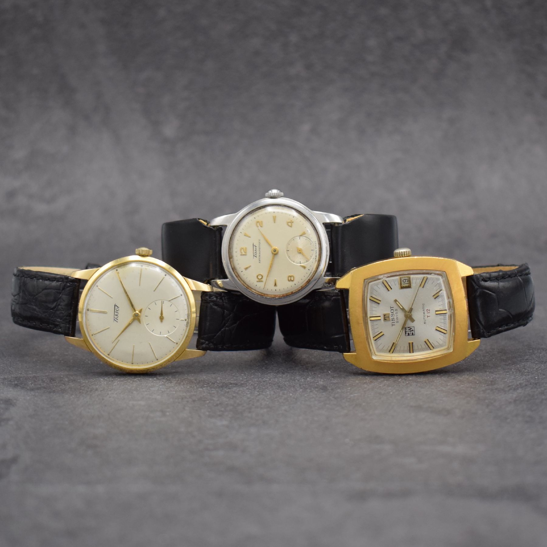 TISSOT 3 Herrenarmbanduhren, Schweiz um 1950 - 1970, 1) T12 Automatik m. Datum, Geh. in Stahl & teils verg., Kal. 784-2 M. ca. 41 x 34 mm, 2) Kal. 27 ...