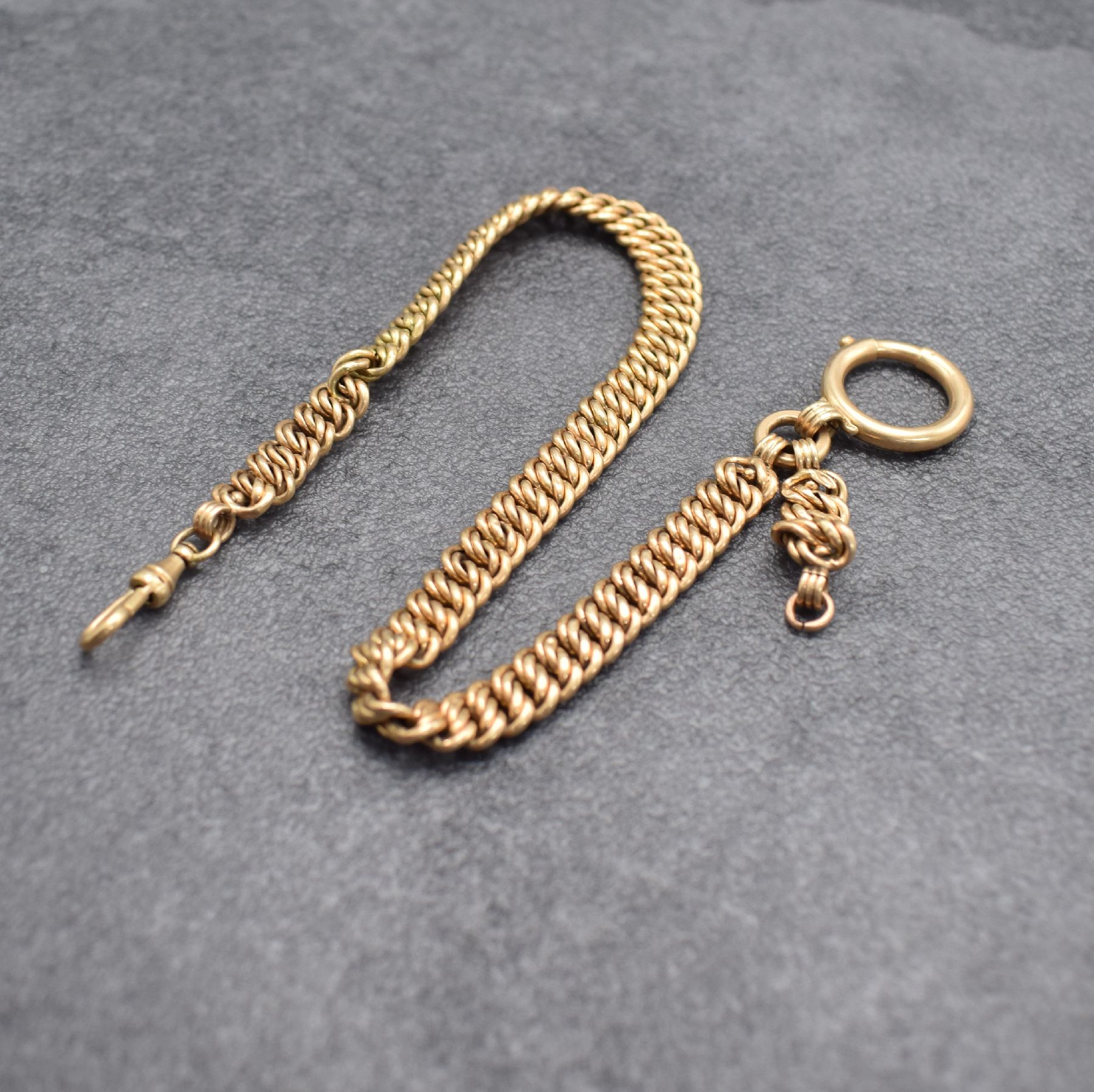 Taschenuhrkette in RG 585/000 mit Federring & Karabiner, Deutschland um 1900, L. ca. 32 cm, Gew. ca. 22g, Nutz- & Rep.-Sp., aus Sammlungsauflösung