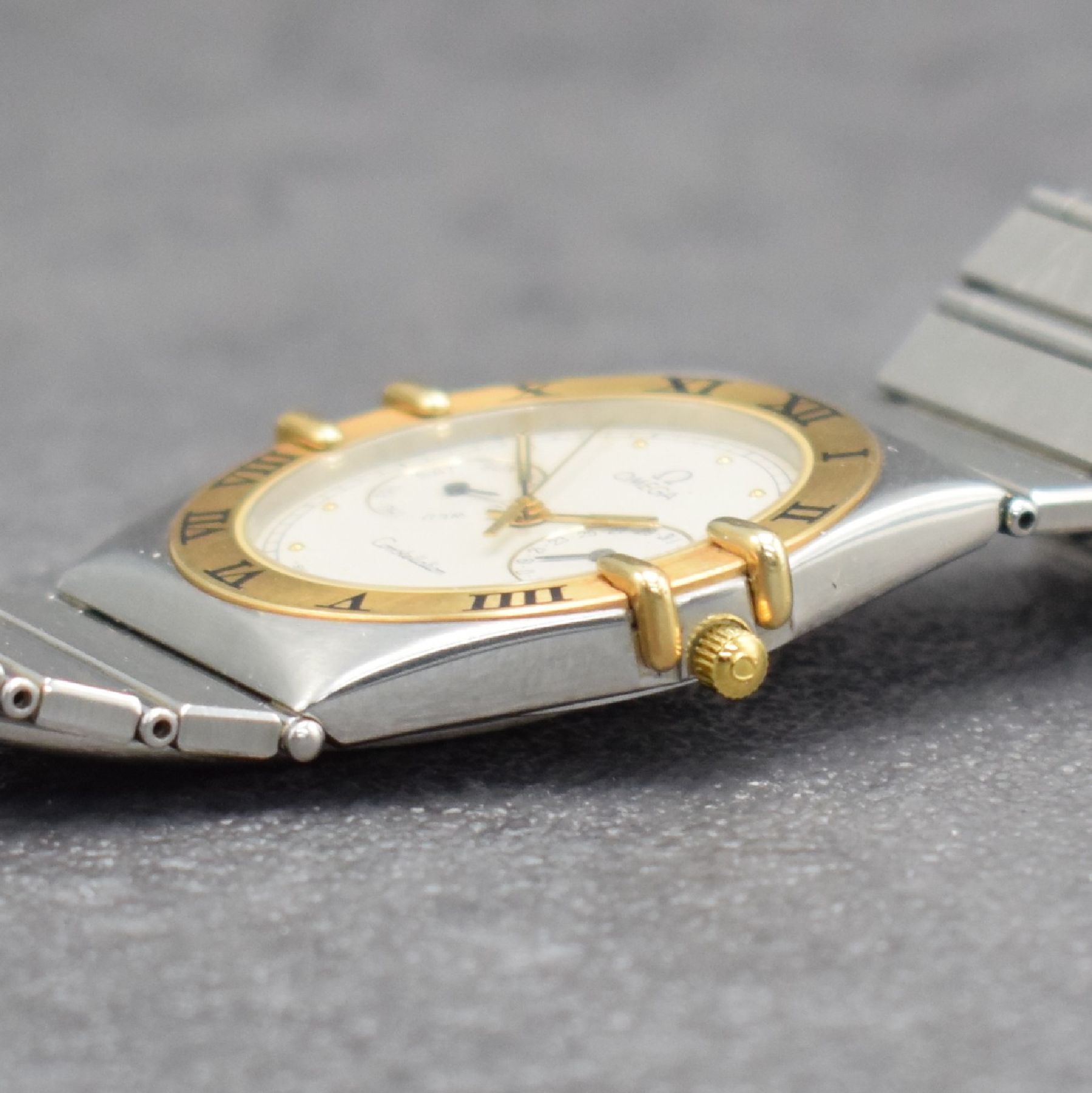 Detail e: OMEGA Constellation Armbanduhr mit Tag & Datum, Schweiz um 1995, quarz, Edelstahlgeh., Goldlünette m. röm. Zahlen, Boden aufgedr., orig. ...