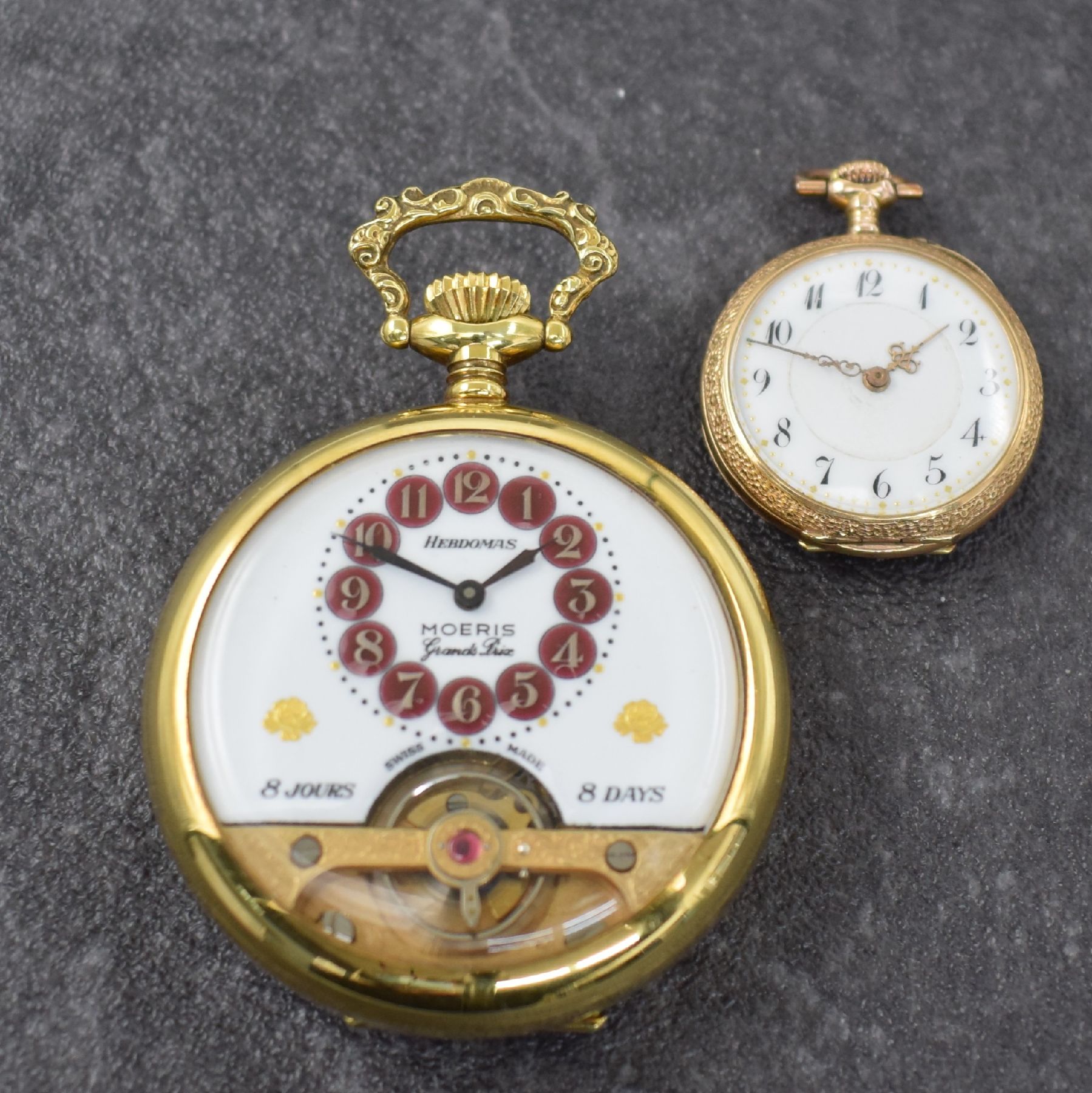 Detail a: Konvolut: 2 offene Taschenuhren, Schweiz um 1900/1950, 1)Hebdomas / Moeris m. 8 Tages- Werk, verg. Geh., Rücks. floral grav., weißes Emailzifferbl. ...