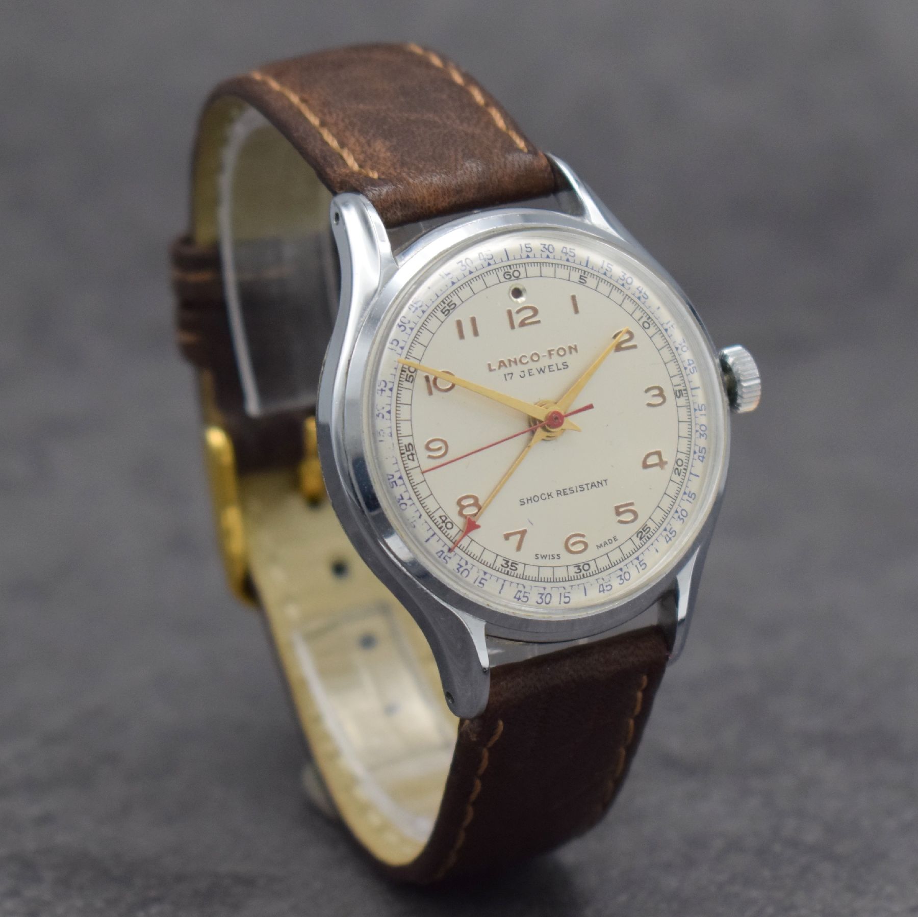 Detail d: LANCO-FON Herrenarmbanduhr mit Weckfunktion,Schweiz um 1950, Handaufzug, verchr. Gehäuse, Edelstahlboden aufgedr., vers. Zifferbl. m. gold. arab. ...