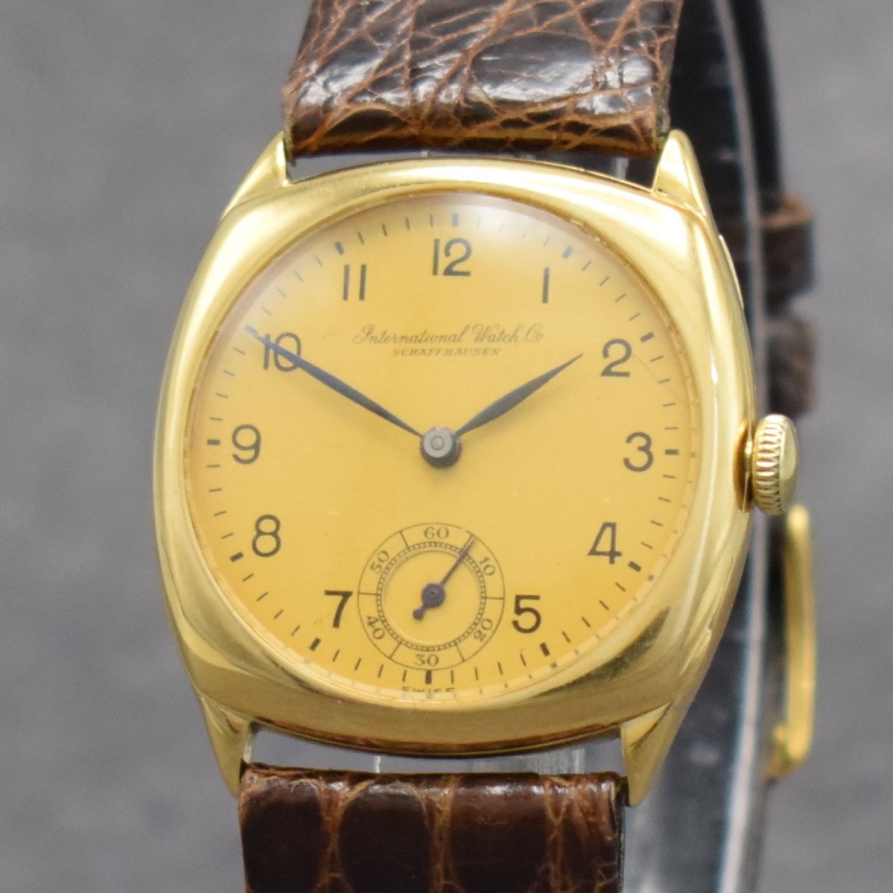Detail c: IWC frühe Armbanduhr in GG 750/000, Schweiz um 1928, Handaufzug, Carré-Cambré Scharniergeh., Lünette aufgedr., matt gold. Zifferbl., arab. ...