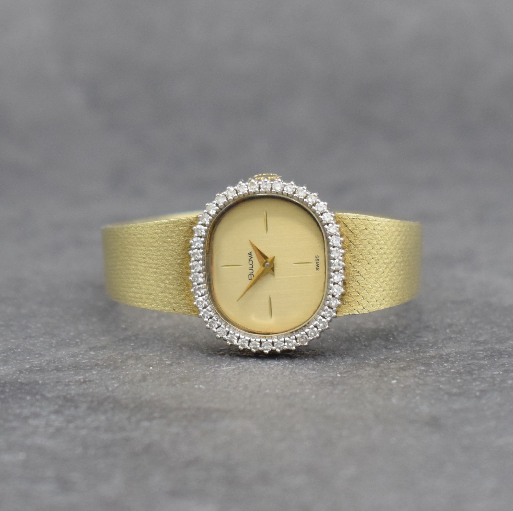BULOVA Damenarmbanduhr in GG 585/000, Schweiz um 1965, Handaufzug, 2-teiliges Geh., Boden aufgedr., Lünette aufwend. mit Diamanten (in WG) bes. zus. ...
