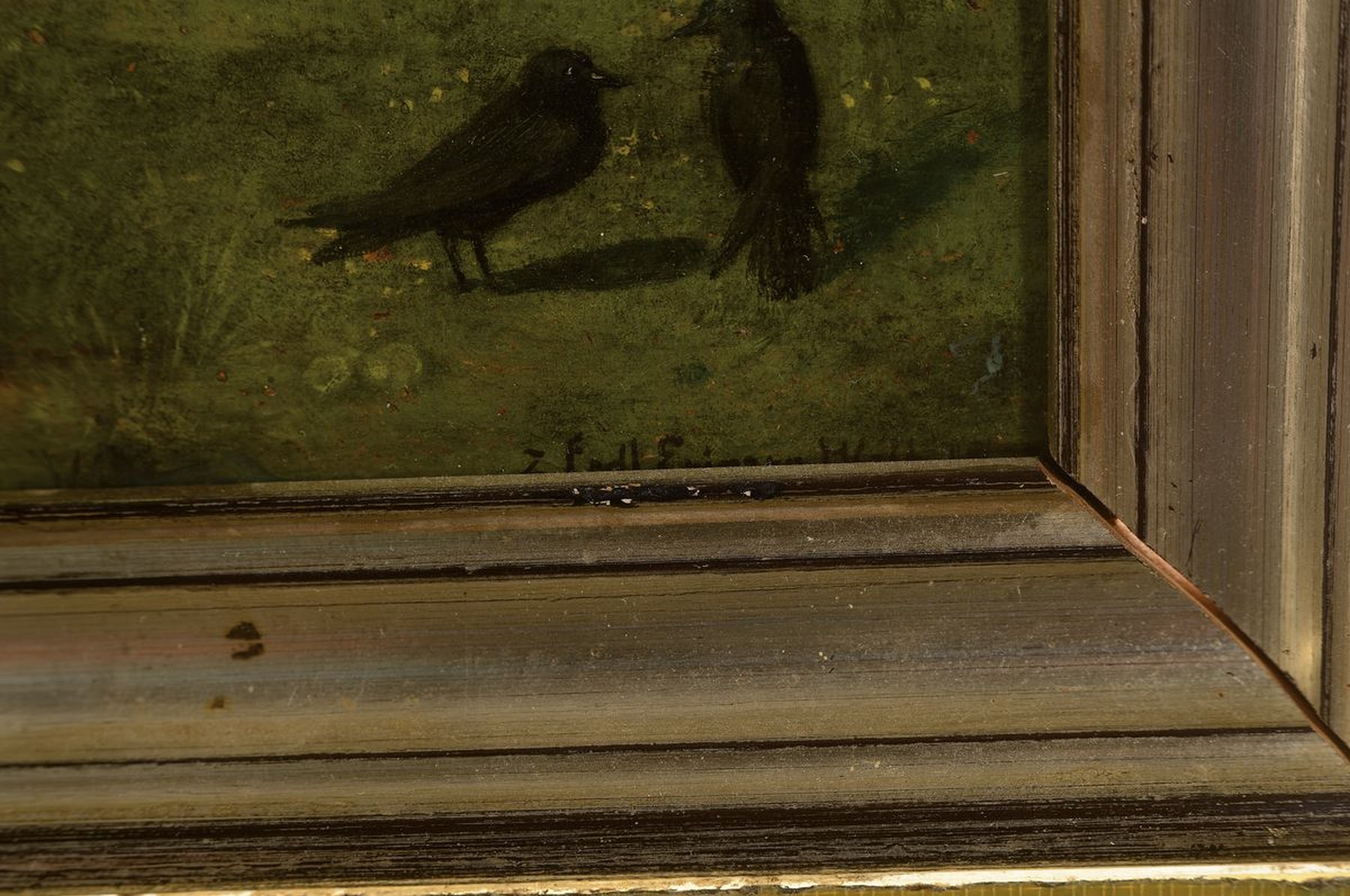 Detail a: M. Kolb, datiert 1877, Jäger sitzt auf einem Stein, vor ihm ein paar Hasen, von hinten stürmt ein Ziegenbock heran, Öl/ Malkarton, rechts unten ...