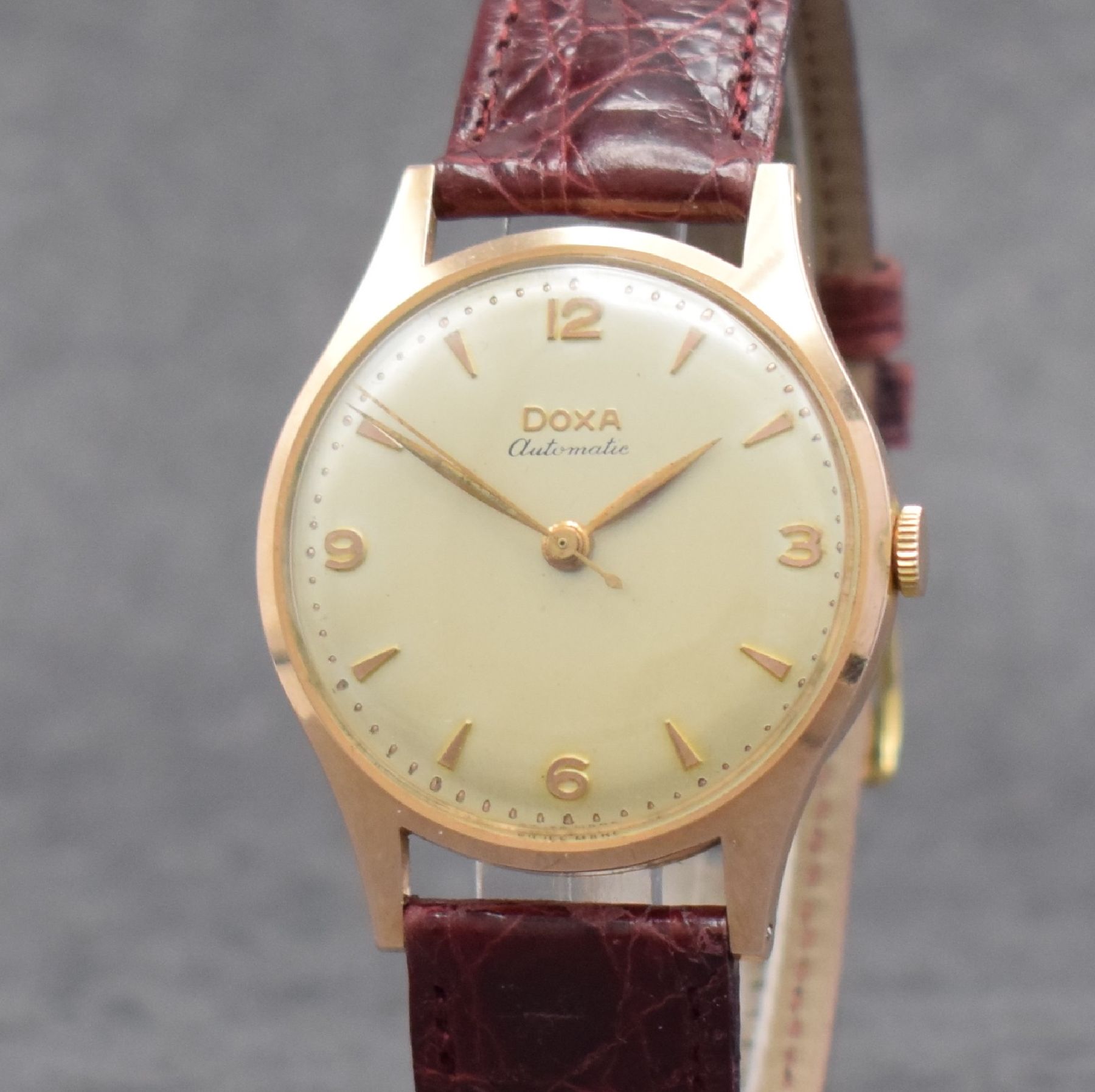 Detail c: DOXA Herrenarmbanduhr in RG 585/000, Schweiz um 1955, Automatik, 2-tlg. Geh., Boden aufgedr., silb. Zifferbl., rotgold. Indizes & Zeiger, ...