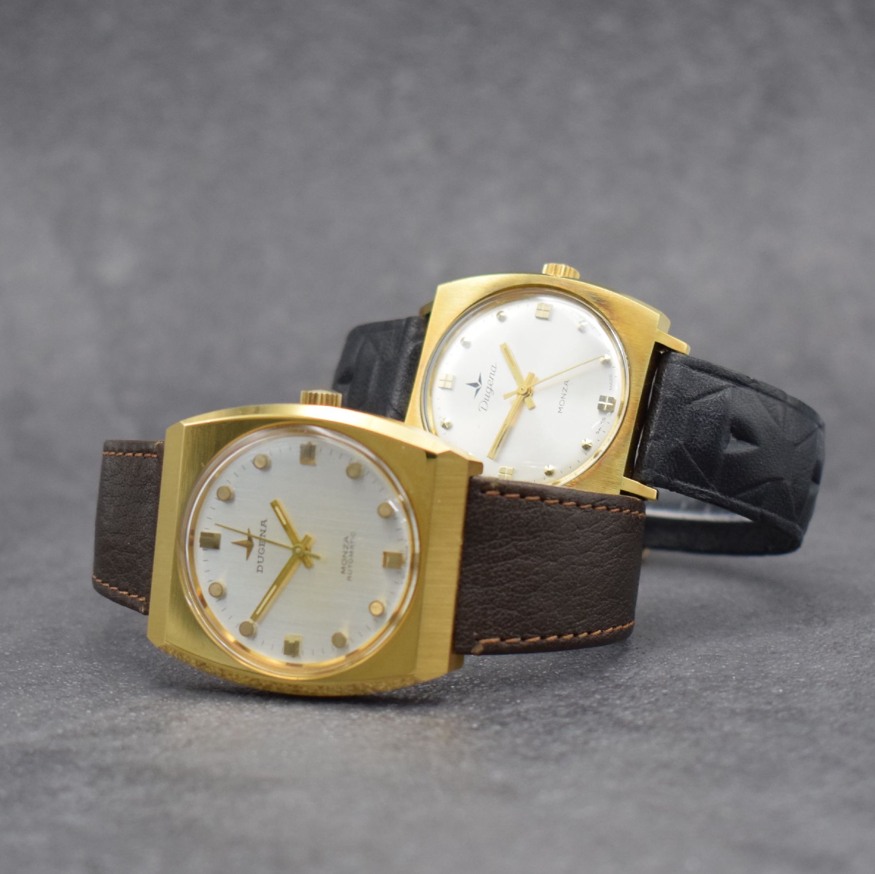 Konvolut: 2 DUGENA Armbanduhren Serie Monza, Schweiz um 1980, beide verg. Metallgeh., Edelstahlböden verschr., silberne Zifferblätter m. aufgel. ...