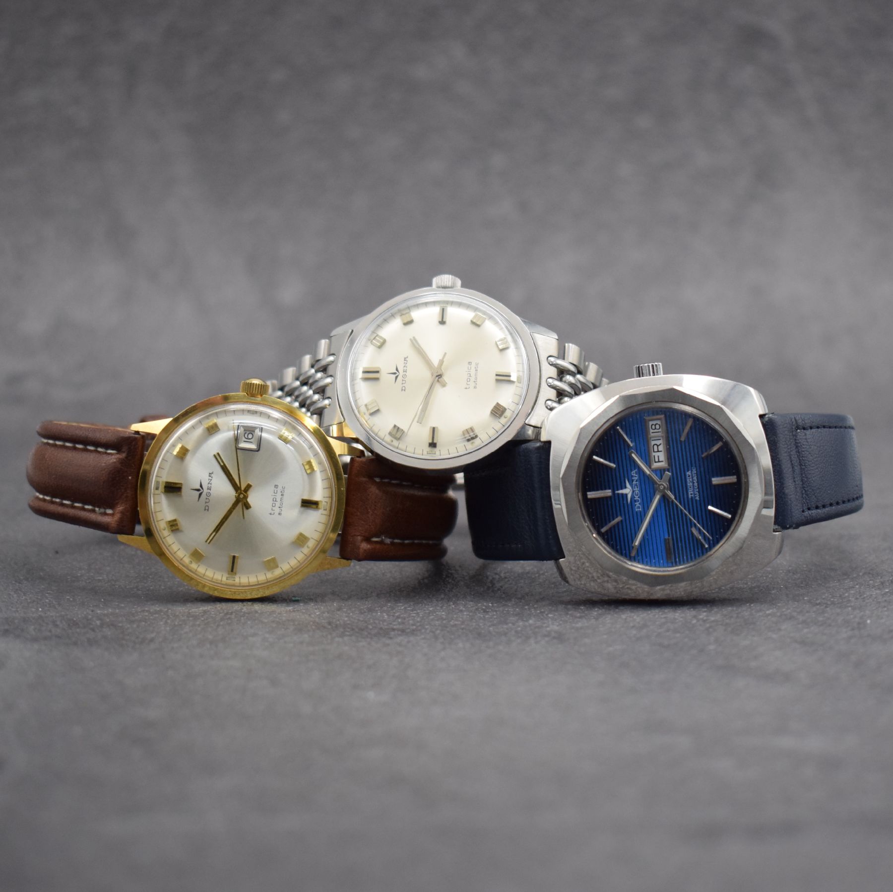 Konvolut: 3 DUGENA Armbanduhren Serie Tropica, Schweiz 1970er Jahre, all Automatik, 1 x verchromt an neutr. Stahlband, Edelstahlboden aufgedr., Kal. ...