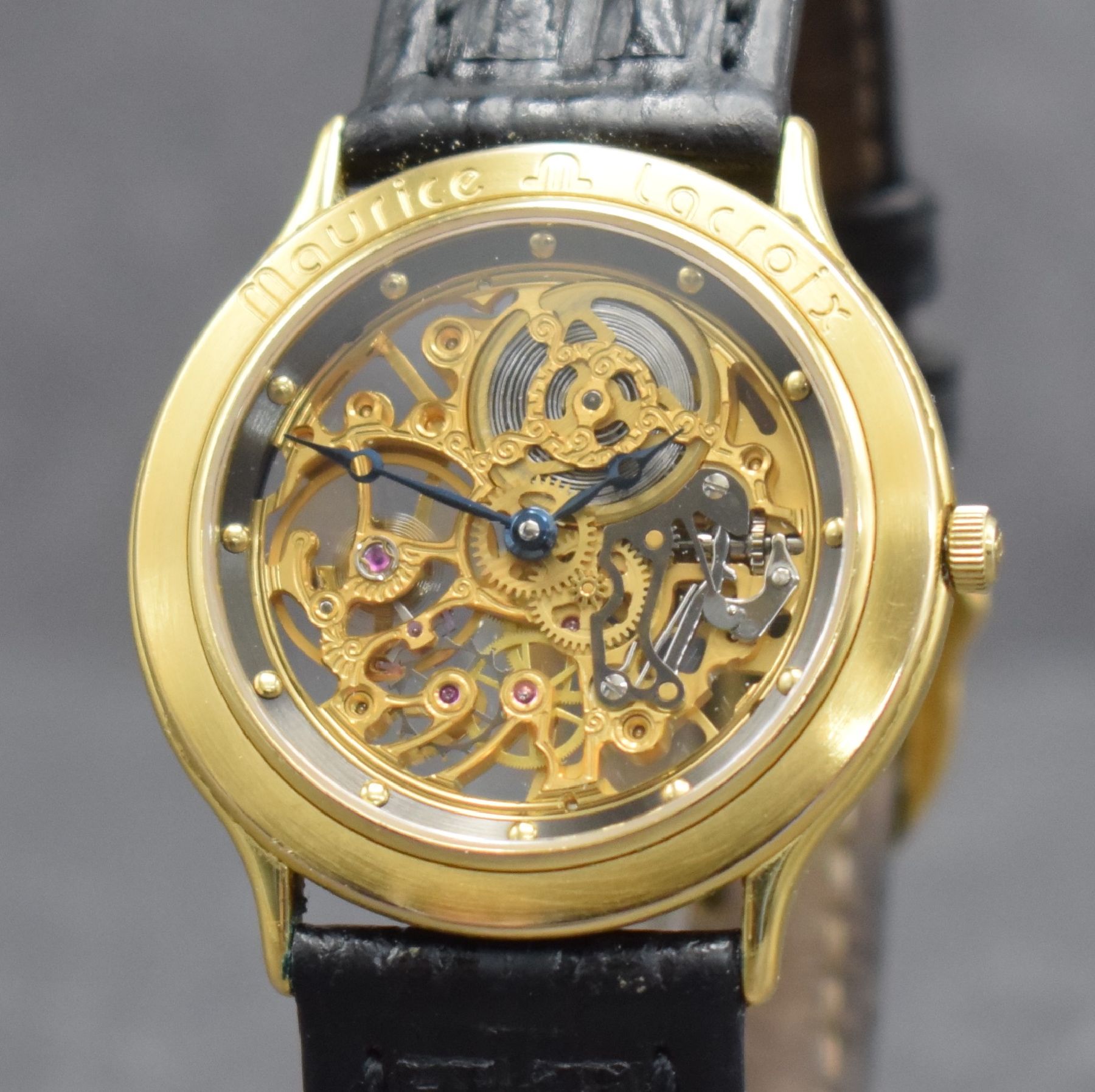 Detail c: MAURICE LACROIX skelettierte Armbanduhr, Schweiz verk. lt. Pap. 07/1988, Handaufzug, verg. Geh. beids. vergl., Boden aufgedr., orig. Lederband m. ...