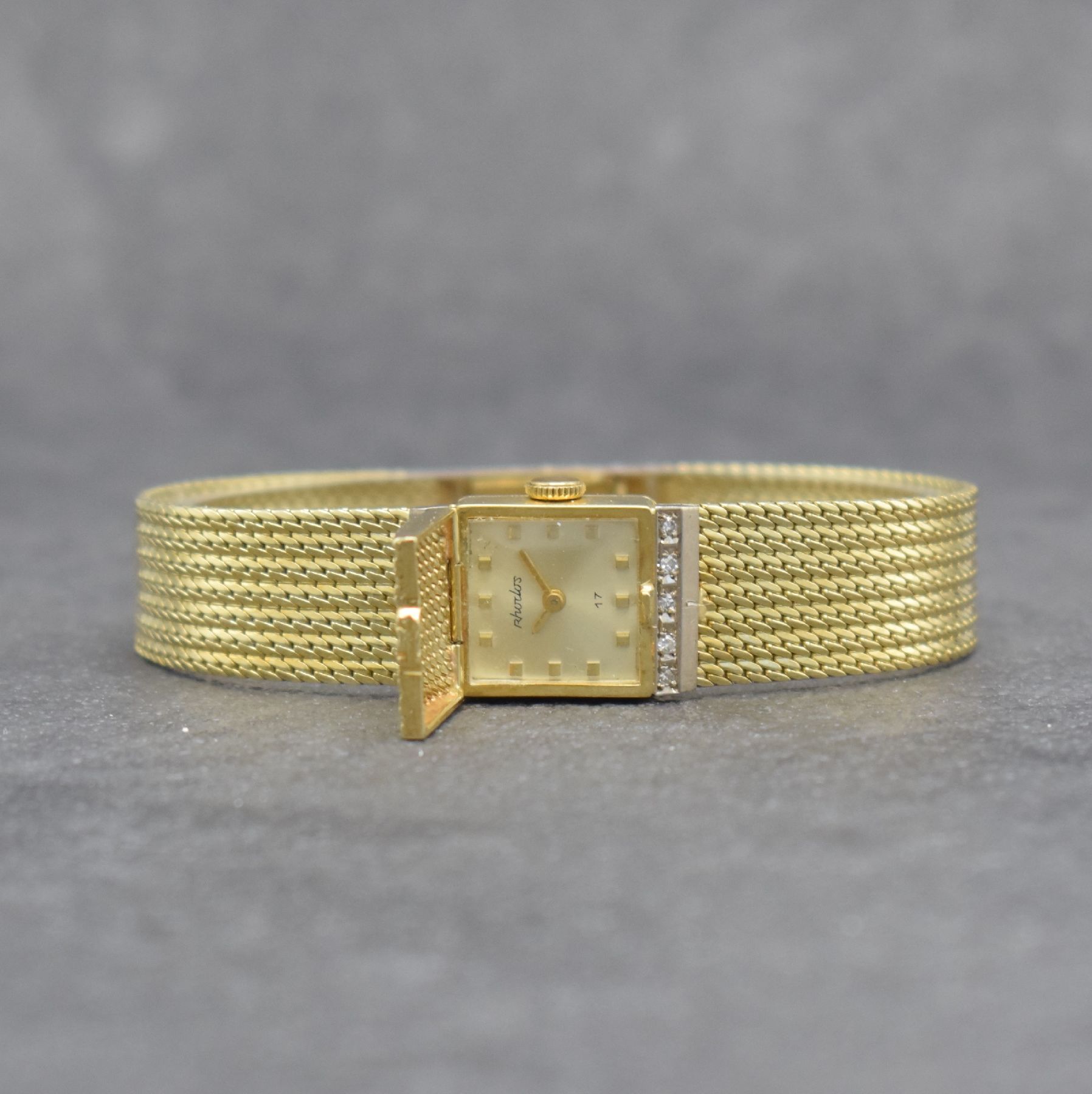 RHODOS Diamantbesetzte Damenarmbanduhr in GG 585/000, Schweiz um 1965, Handaufzug, durchgehendes Milanaiseband, silb. Zifferbl. unter ...
