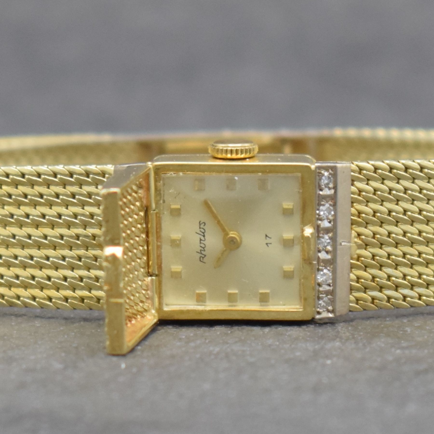 Detail a: RHODOS Diamantbesetzte Damenarmbanduhr in GG 585/000, Schweiz um 1965, Handaufzug, durchgehendes Milanaiseband, silb. Zifferbl. unter ...