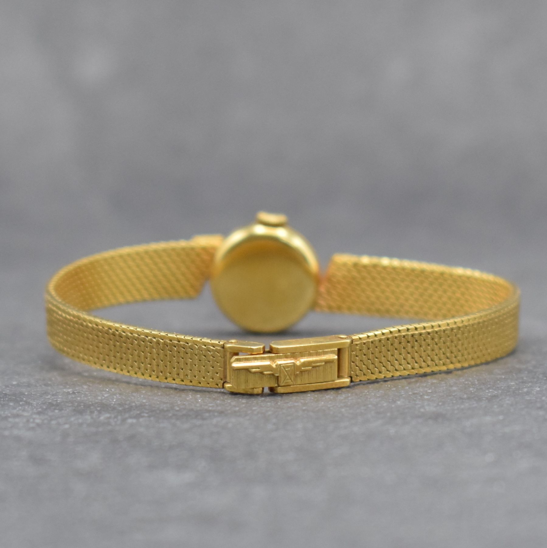 Detail d: LONGINES Damengoldbanduhr in GG 750/000, Schweiz um 1965, Handaufzug, gedr. Geh., anges. Milanaiseband, orig. Krone, silb. Zifferbl., gold. Indizes & ...