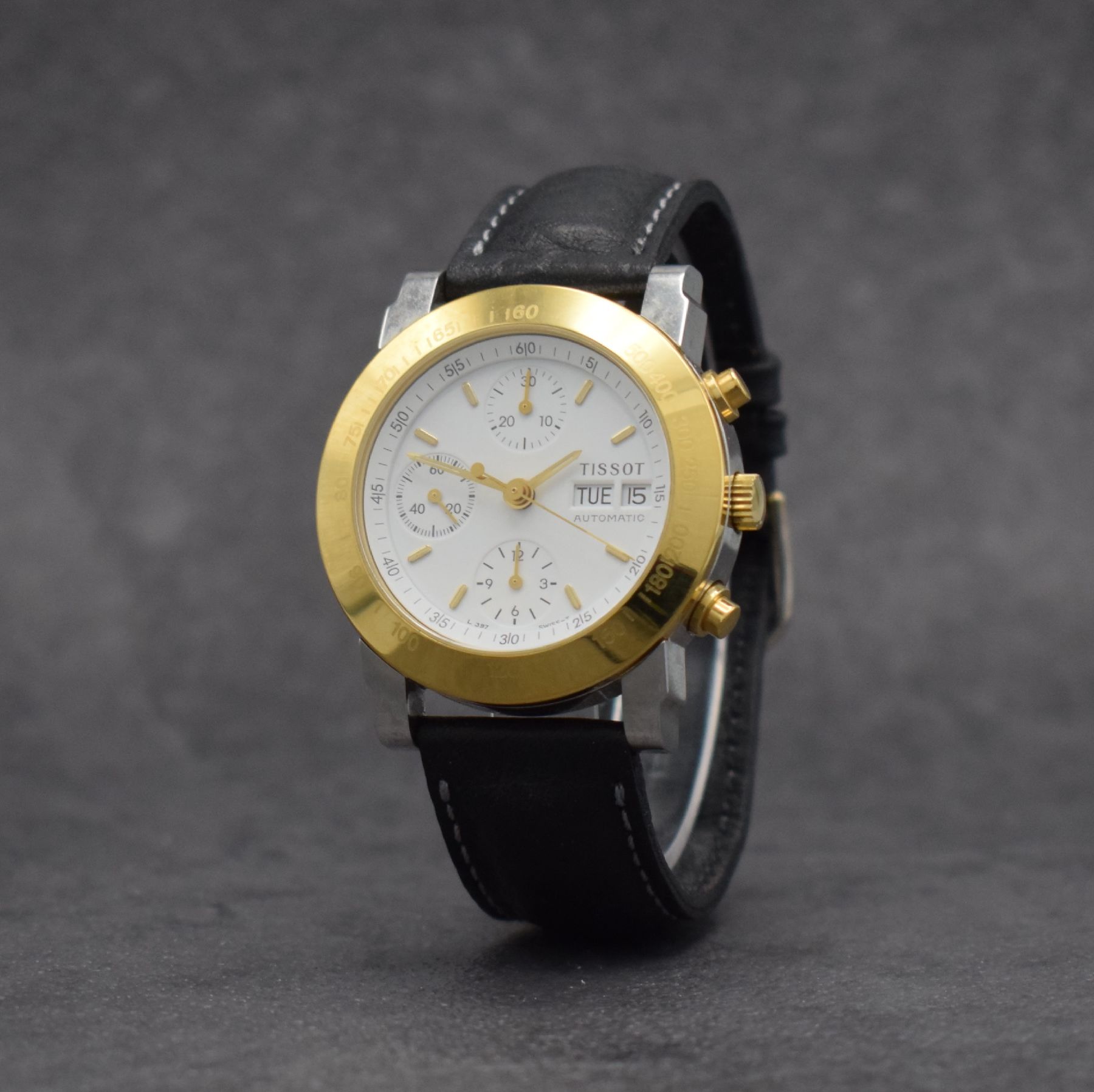 Detail b: TISSOT Herrenchronograph in Stahl/vergoldet, Schweiz um 2000, Automatik, gedr. Geh. m. verg. Tachymeter-Lünette, weißes Zifferbl., gold. Indizes & ...