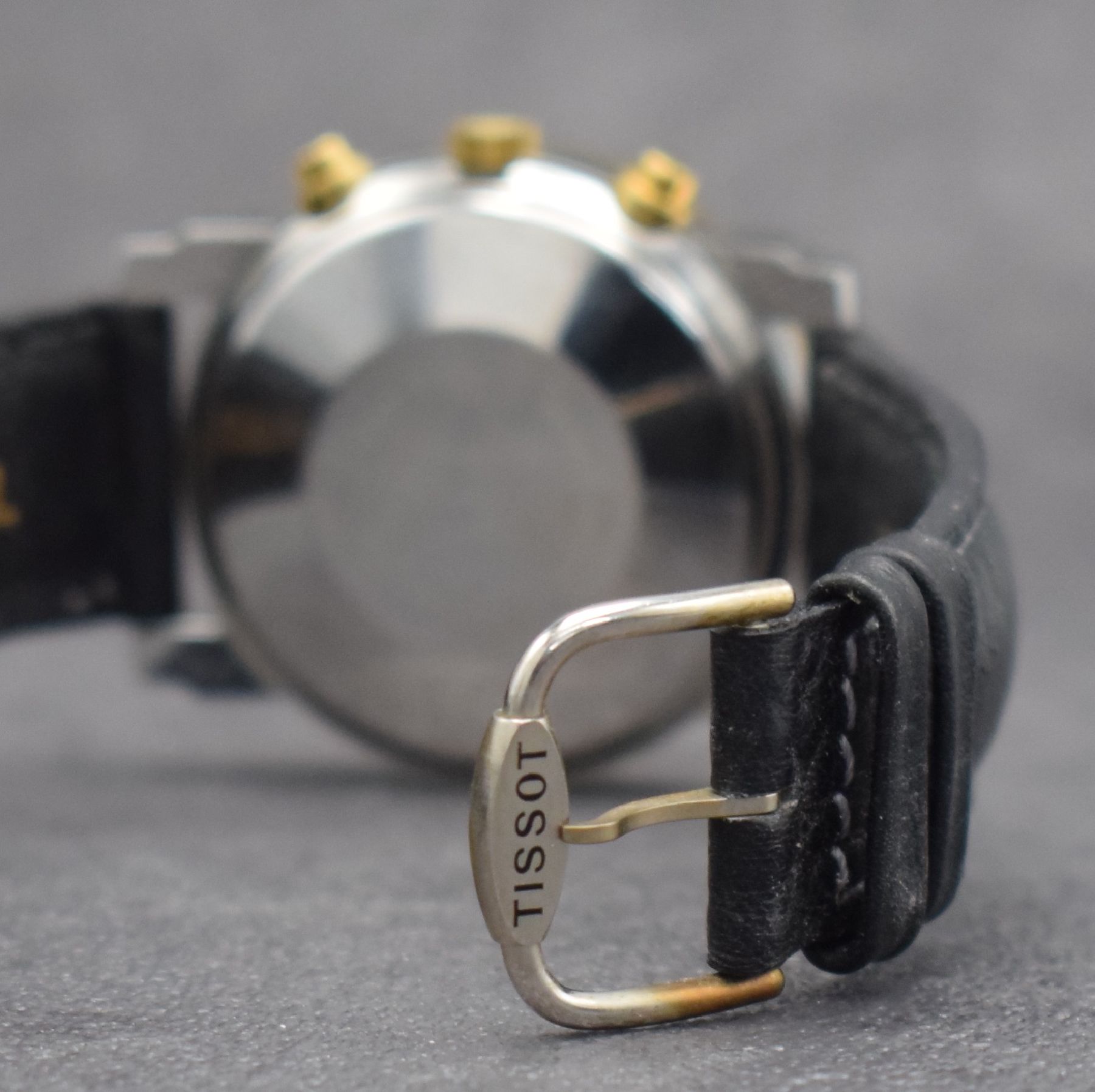 Detail d: TISSOT Herrenchronograph in Stahl/vergoldet, Schweiz um 2000, Automatik, gedr. Geh. m. verg. Tachymeter-Lünette, weißes Zifferbl., gold. Indizes & ...