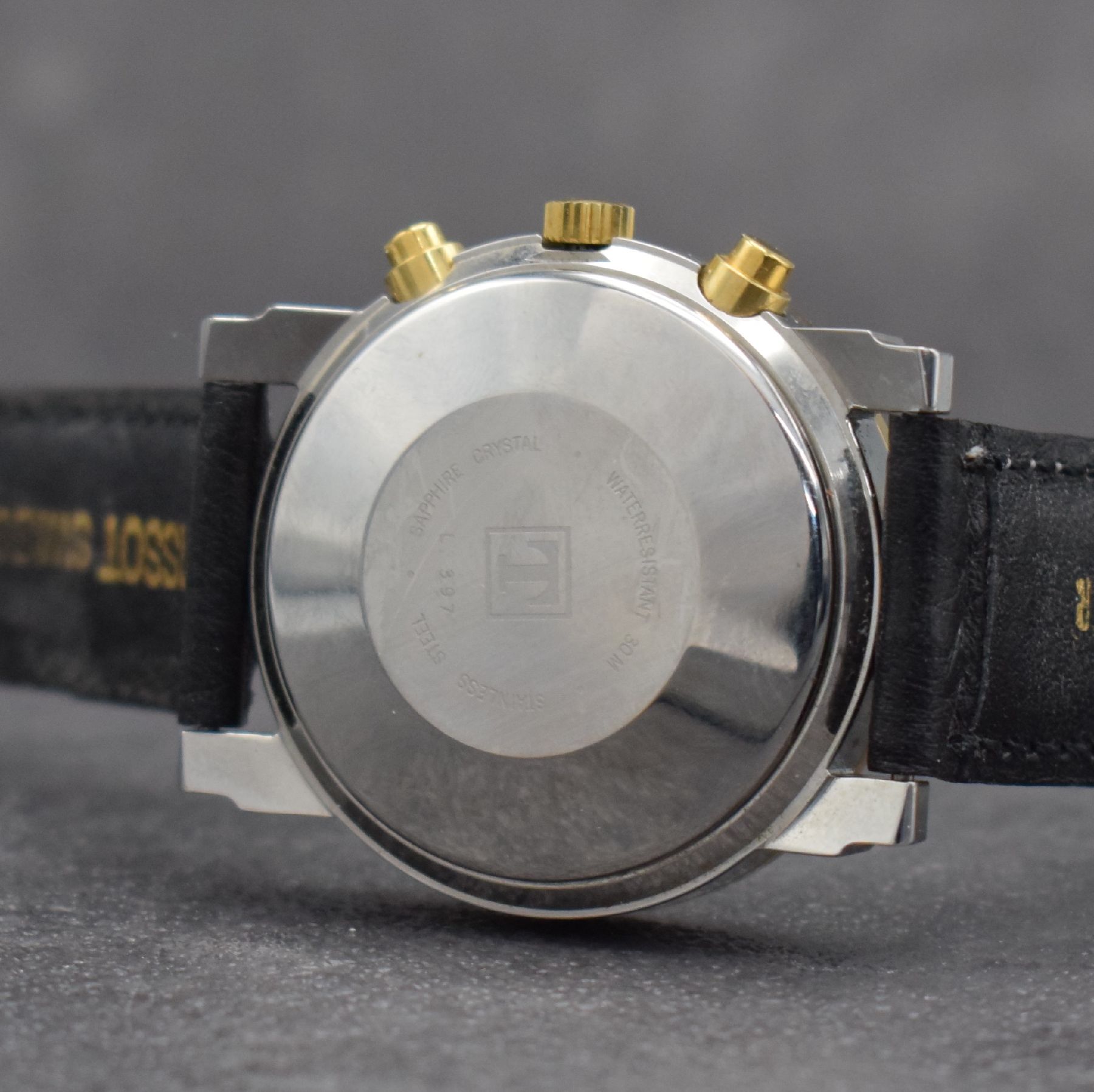 Detail e: TISSOT Herrenchronograph in Stahl/vergoldet, Schweiz um 2000, Automatik, gedr. Geh. m. verg. Tachymeter-Lünette, weißes Zifferbl., gold. Indizes & ...