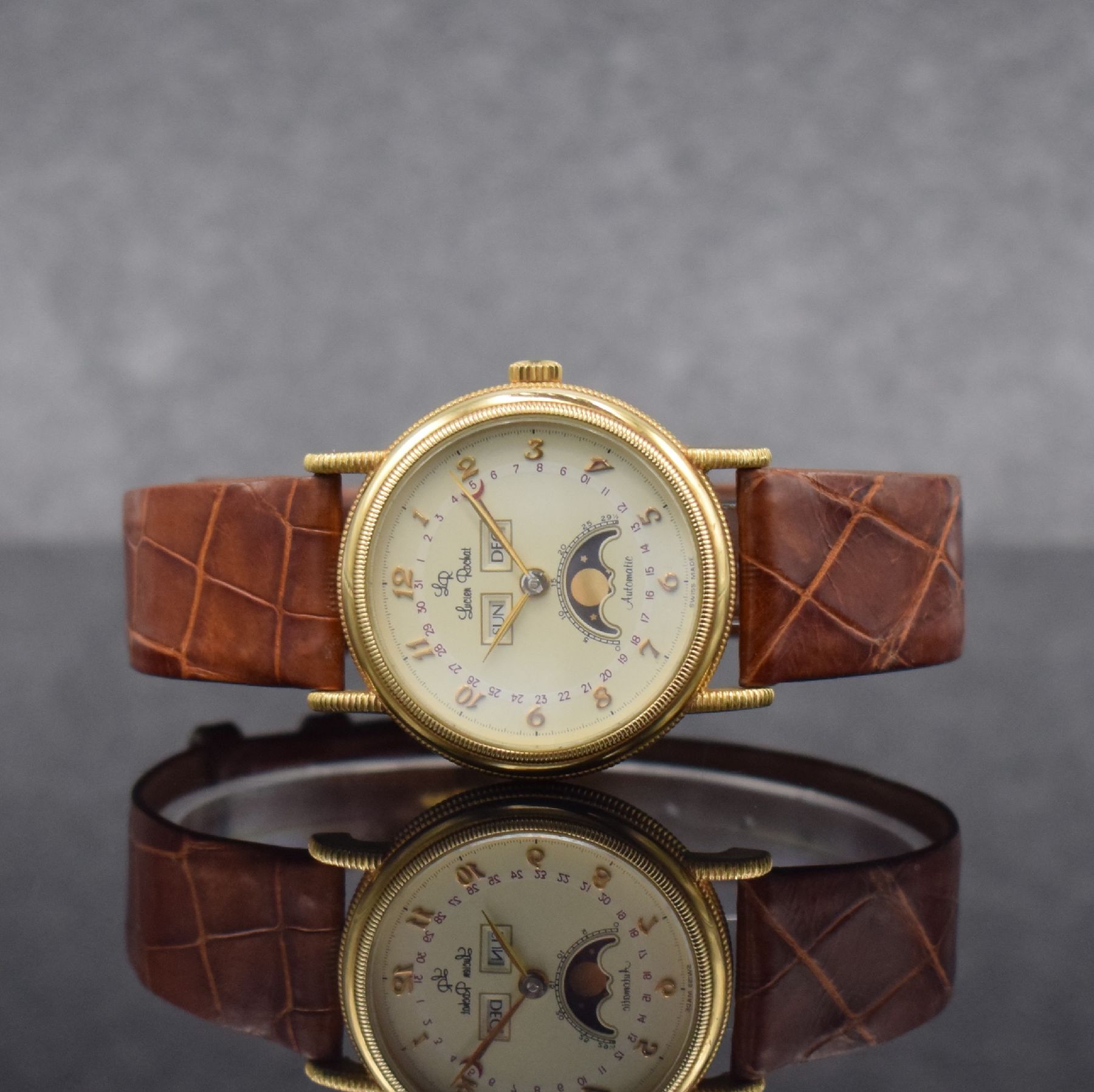 LUCIEN ROCHAT Vollkalender-Herrenarmbanduhr in GG 750/000, Schweiz um 1990, Automatik, 3-tlg. gedr. Geh., Lünette, Anstöße & Rand geriffelt, ...