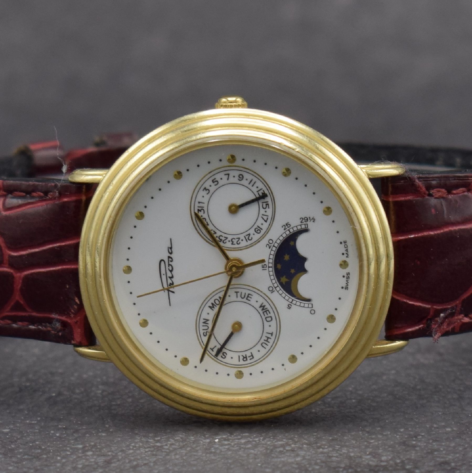 Detail a: PRIOSA Armbanduhr in GG 585/000 mit Mondphase, Schweiz um 1990, quarz, Boden aufgedr., weißes Zifferbl. m. gold. Indizes & Zeigern, Tag & Datum, D. ...
