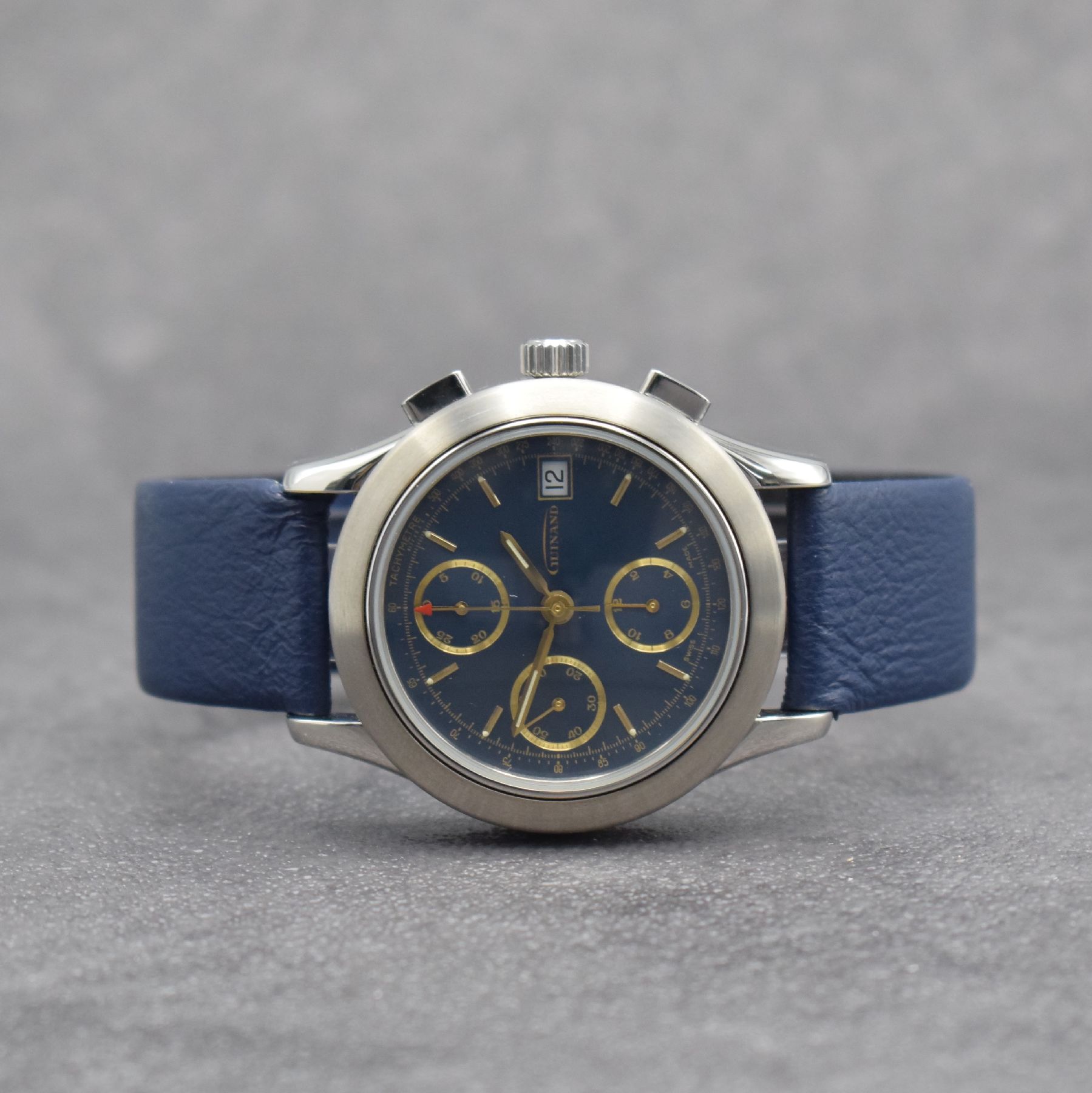 GUINAND nahezu neuwertige Herrenarmbanduhr mit Chronograph, Schweiz um 2000, Automatik, verschr. Geh. in Edelstahl, blaues Zifferbl. m. aufges. gold. ...