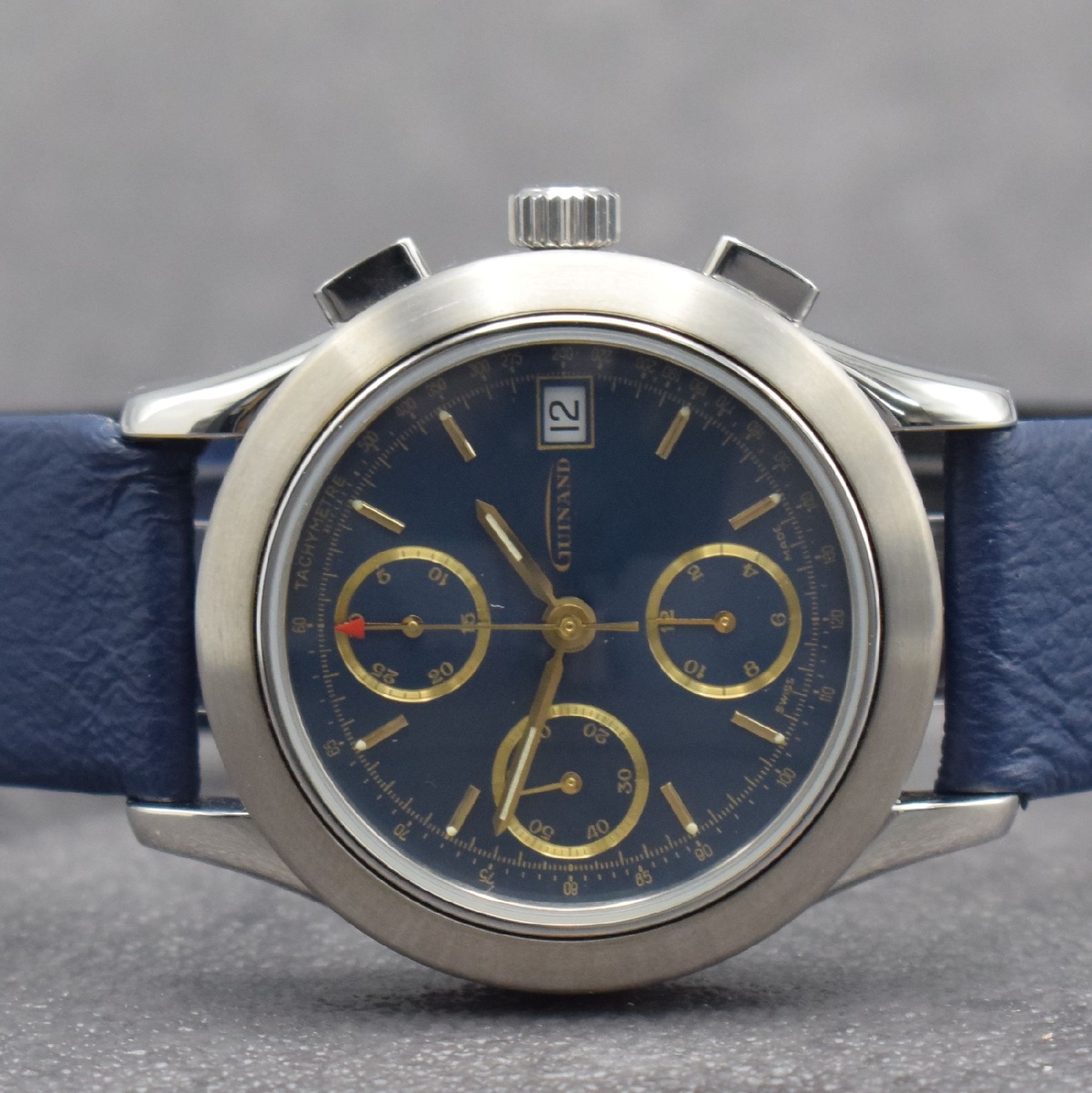 Detail a: GUINAND nahezu neuwertige Herrenarmbanduhr mit Chronograph, Schweiz um 2000, Automatik, verschr. Geh. in Edelstahl, blaues Zifferbl. m. aufges. gold. ...