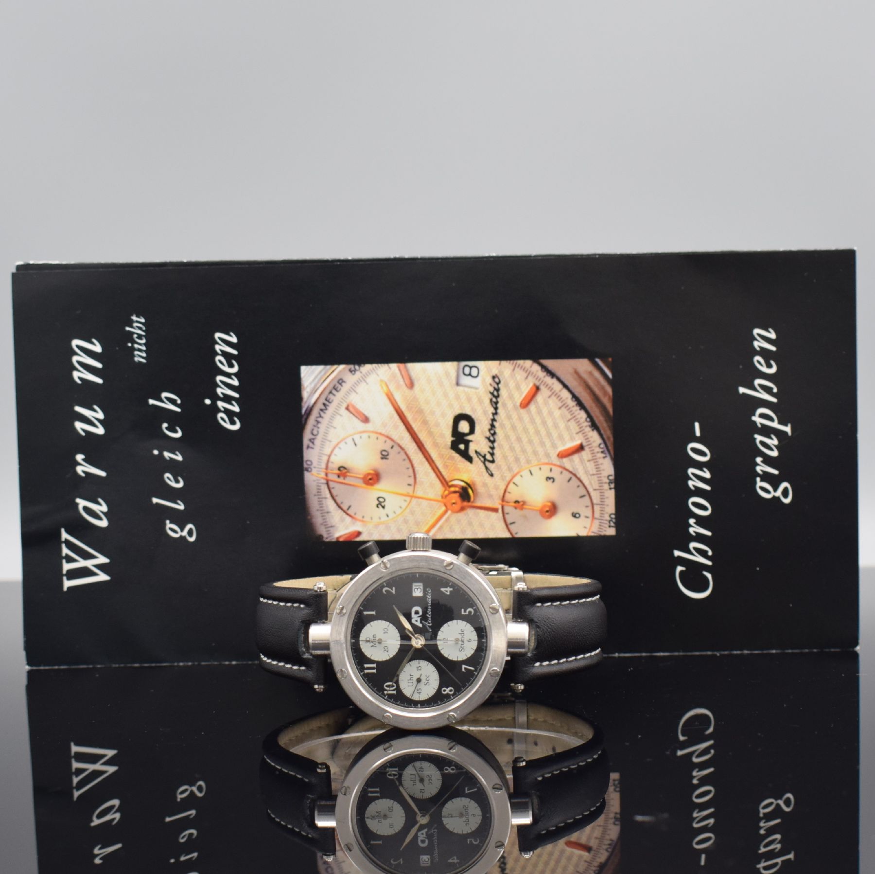 Detail e: AD ausgefallener Chronograph in Edelstahl, Automatik, 3-teil. verschr. Gehäuse, beids. vergl., Krone verschr., schwarzes Zifferbl. m. röm. Zahlen & ...
