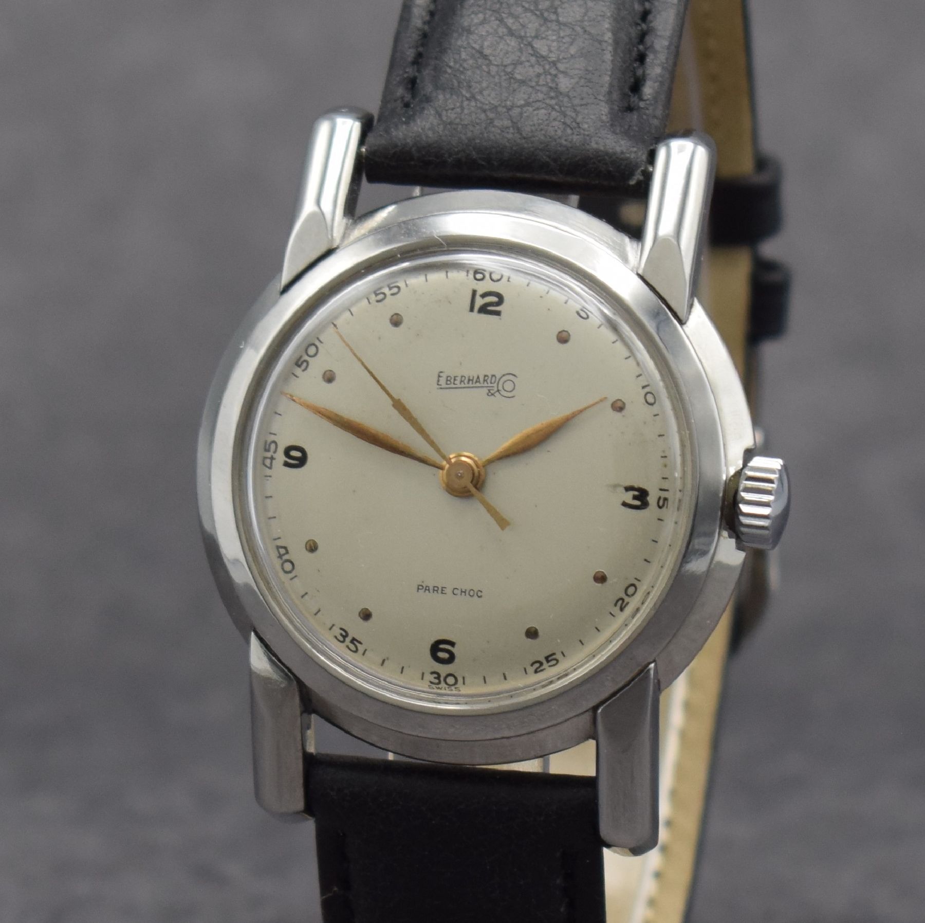 Detail c: EBERHARD & Co. Armbanduhr, Handaufzug, Schweiz um 1950, 3-teil. Edelstahlgeh., Boden verschr., Glasrand aufgedr., silb. Zifferbl. altersbed. get., ...