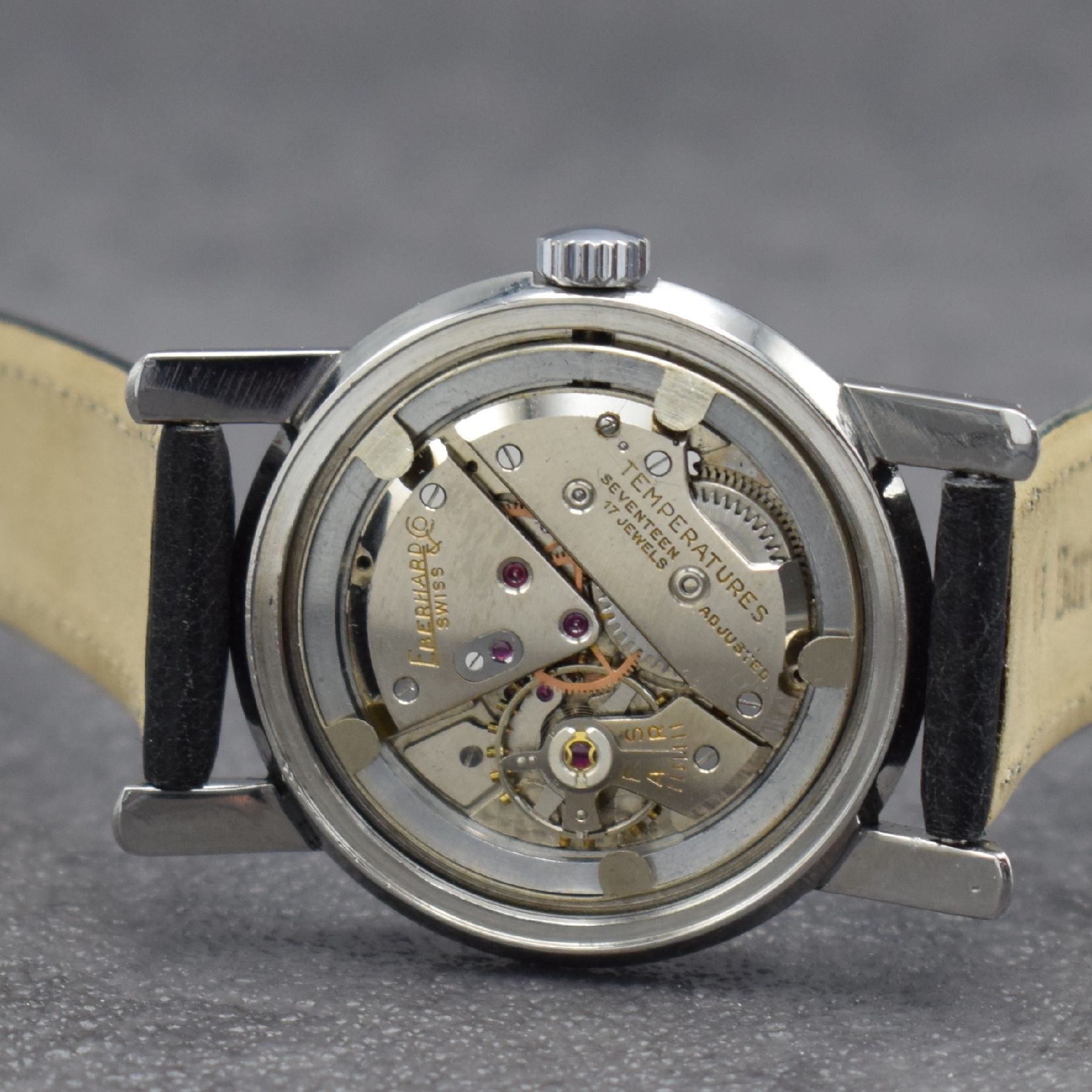 Detail e: EBERHARD & Co. Armbanduhr, Handaufzug, Schweiz um 1950, 3-teil. Edelstahlgeh., Boden verschr., Glasrand aufgedr., silb. Zifferbl. altersbed. get., ...