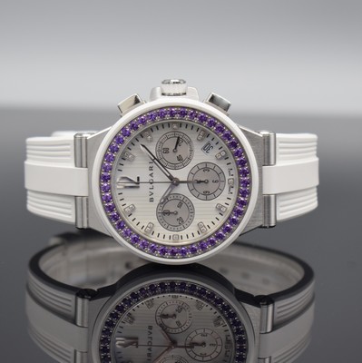 Image BULGARI Diagono to 500 pieces limited ladies chronograph with amethysts & diamonds, self winding, reference DG 40 S CH, screwed down stainless steel case, winding crown screwed down, original rubber strap with buckle, white dial with diamond set indices, silvered hands, date, constant second at 3, diameter approx. 41 mm, original box & papers enclosed, condition 1-2