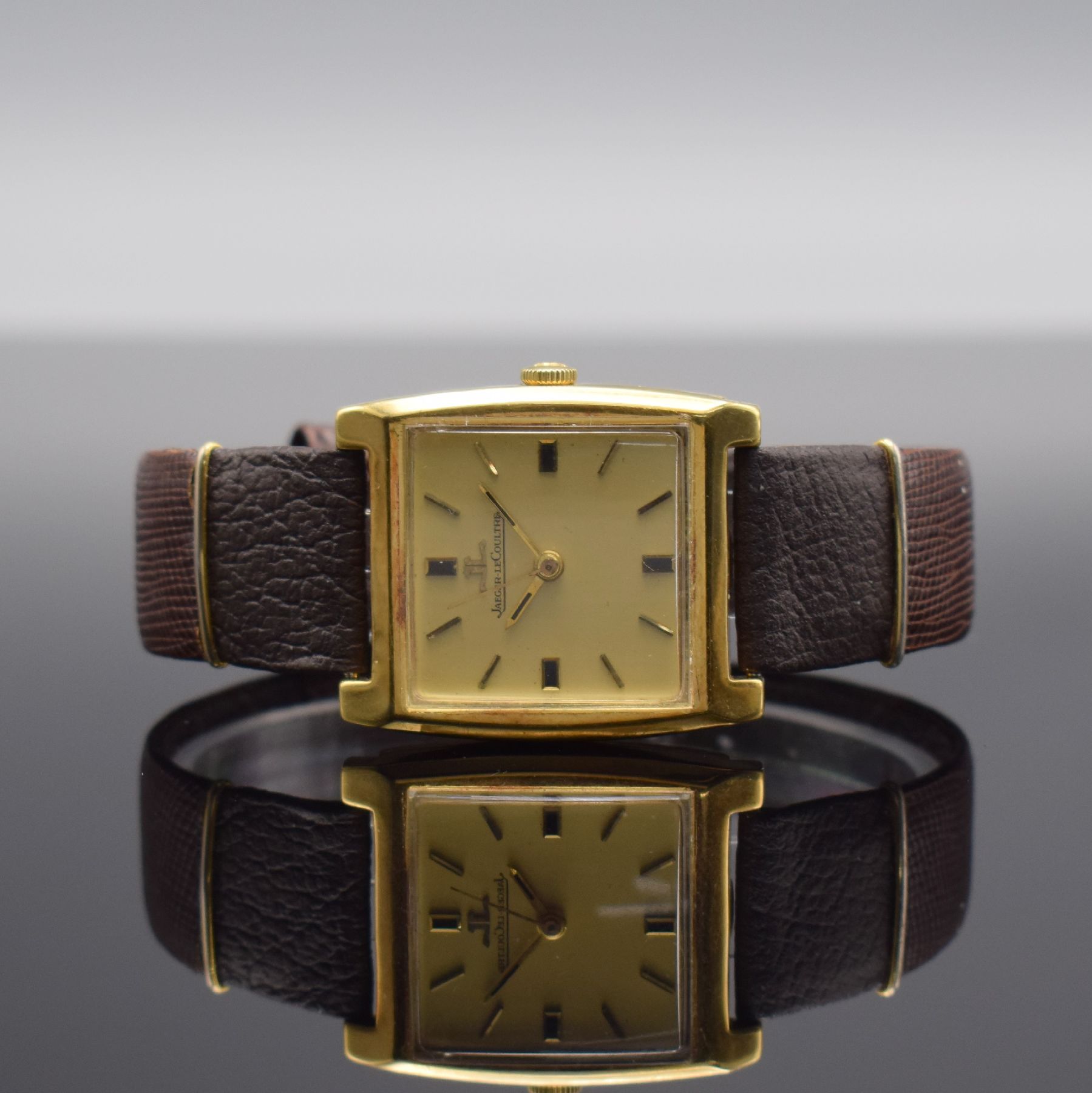 Jaeger-LeCoultre Armbanduhr in GG 750/000, Schweiz um 1970, Handaufzug, rechteck. Geh. teils angel., Boden aufgedr., gold. Zifferbl. m. gold. aufges. ...