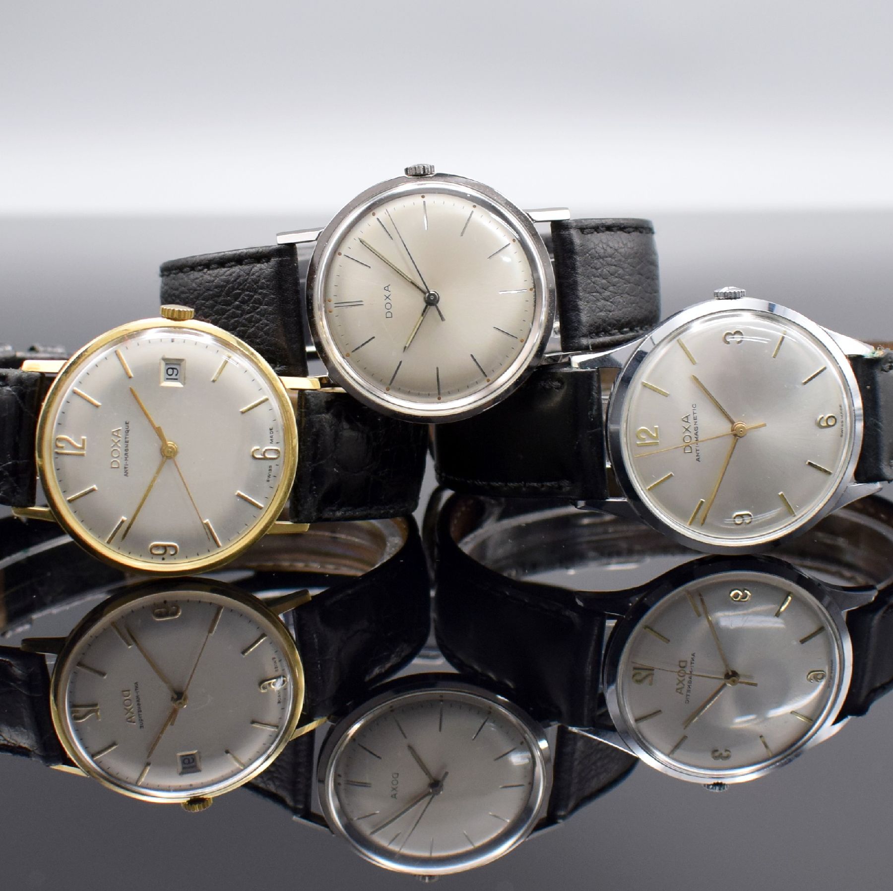 Detail a: DOXA 3 Herrenarmbanduhren, Schweiz um 1960, Handaufzug, 1.) GG 585/000, Kal. 45, 17 St., Feinreg., D. ca. 34,5 mm, EZ 2-3, 2.) Edelstahl, Kal. 103, ...