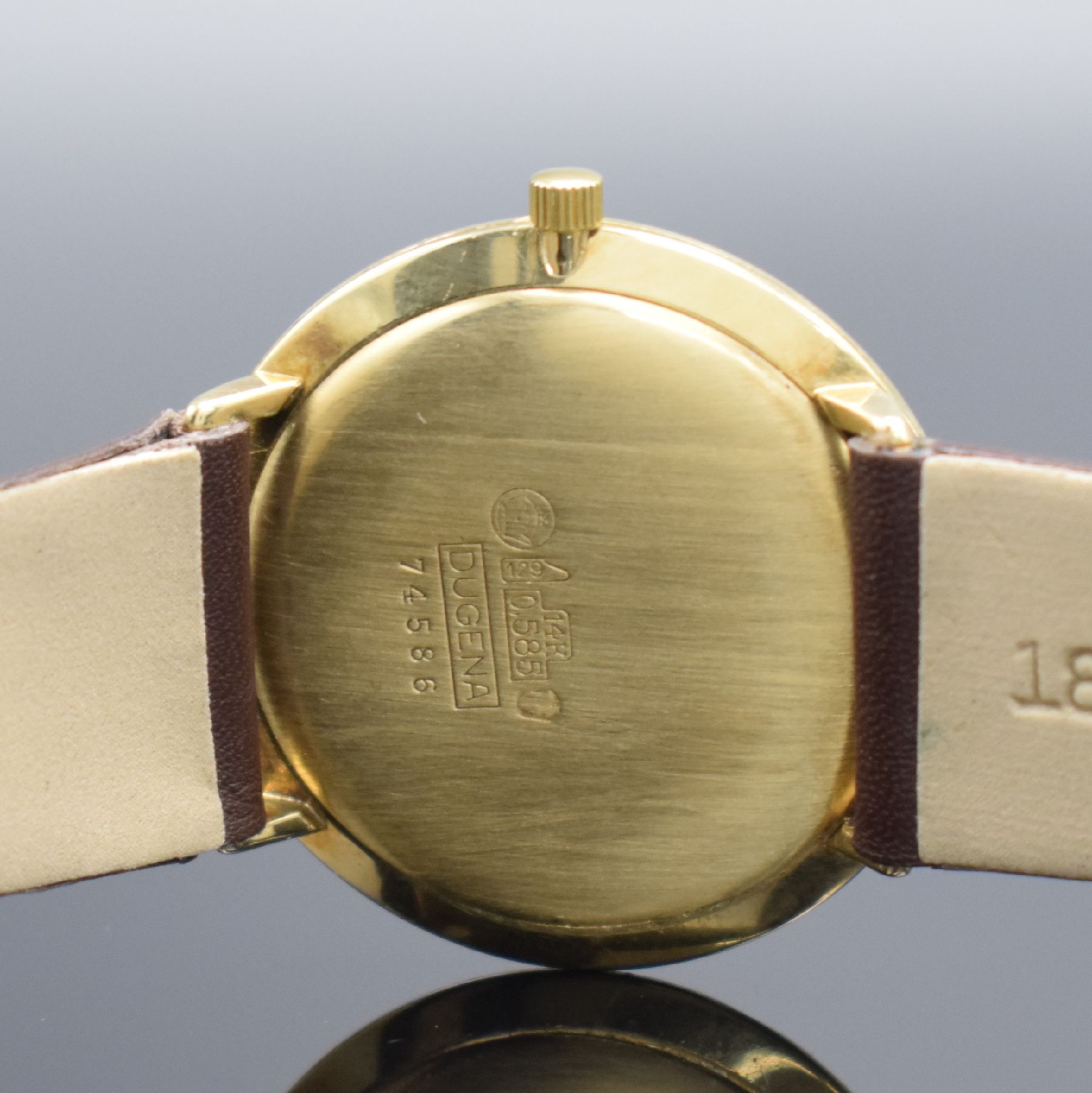 Detail f: DUGENA Armbanduhr in GG 585/000, Schweiz um 1960, Handaufzug, 3-teil. Geh., Boden & Glasrand aufgedr., silb. Zifferbl. m. aufges. Std.-Ind., gold. ...