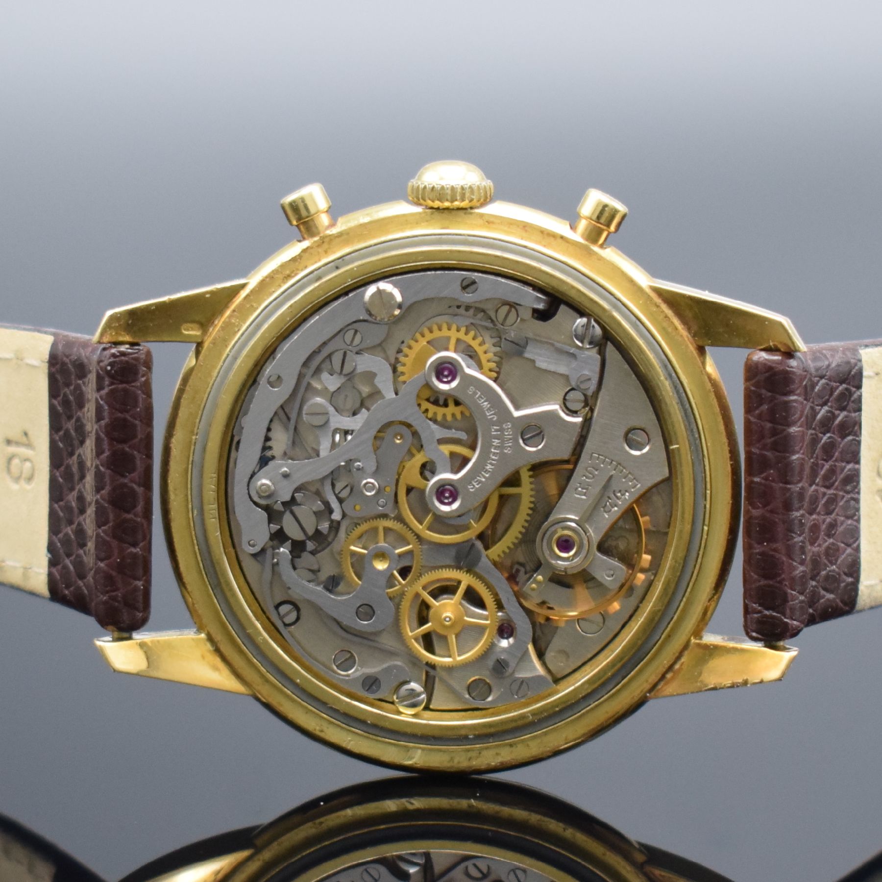 Detail e: NIVADA Schaltradchronograph in GG 750/000, Schweiz um 1950, Handaufzug, 2-tlg. Geh., Boden aufgedr., silb. Zifferbl. pat., gold. Ind. & Zahlen, orig. ...