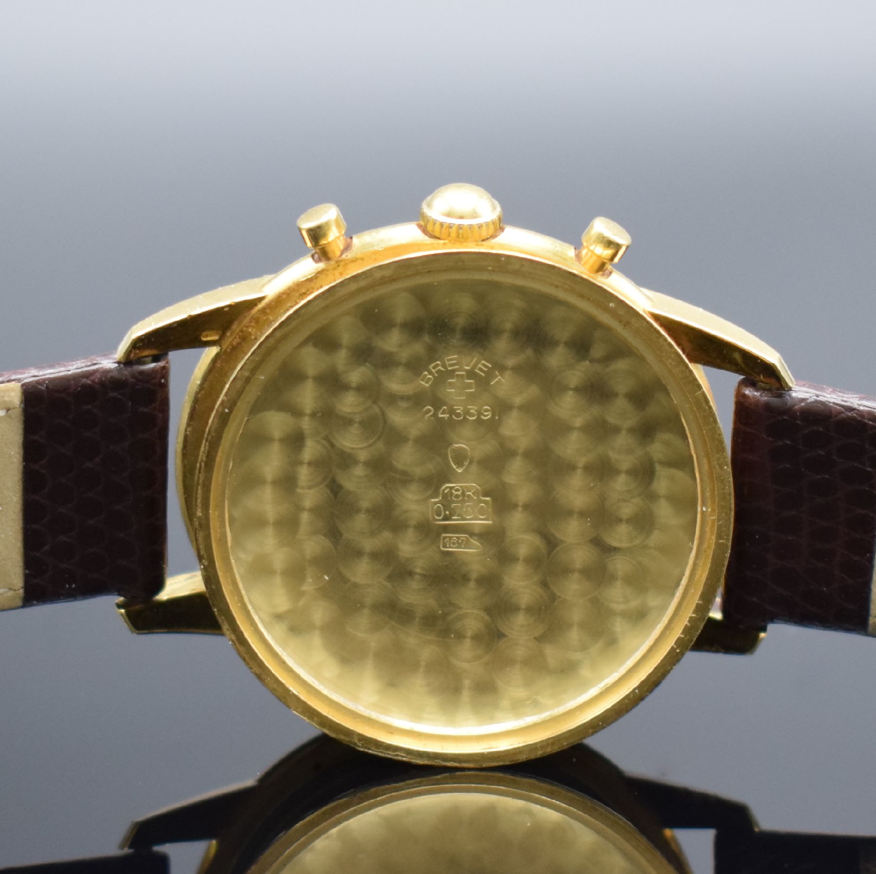Detail f: NIVADA Schaltradchronograph in GG 750/000, Schweiz um 1950, Handaufzug, 2-tlg. Geh., Boden aufgedr., silb. Zifferbl. pat., gold. Ind. & Zahlen, orig. ...