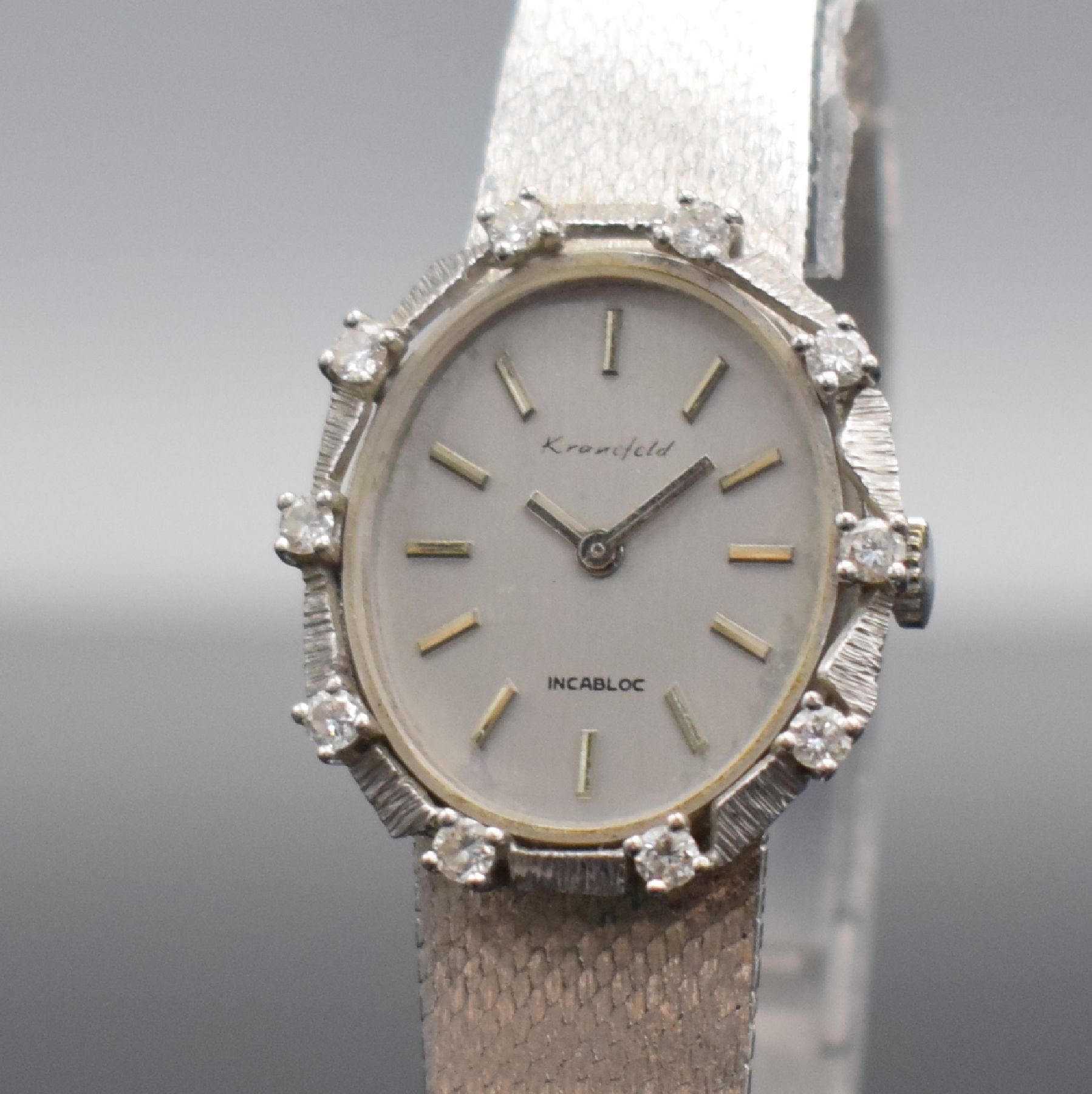 Detail c: KRANEFELD Damenarmbanduhr mit Diamantbesatz in WG 585/000, Schweiz um 1970, Handaufzug, Geh. an WG 585/000 Band, Boden aufgedr., silb. Zifferbl. m. ...