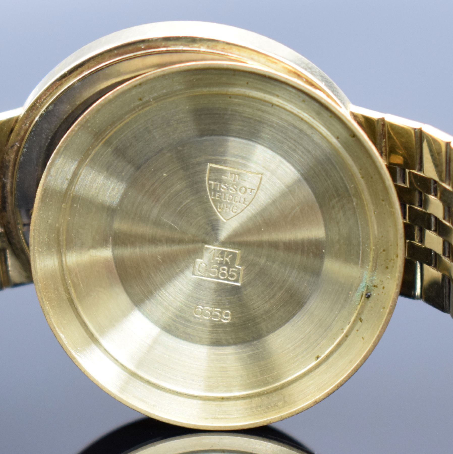 Detail j: TISSOT Herrenarmbanduhr in GG 585/000, Schweiz um 1965, Automatik, 2-teil. Geh., Boden aufgedr., orig. GG 585/000 Band, silb. Zifferbl. m. aufges. ...