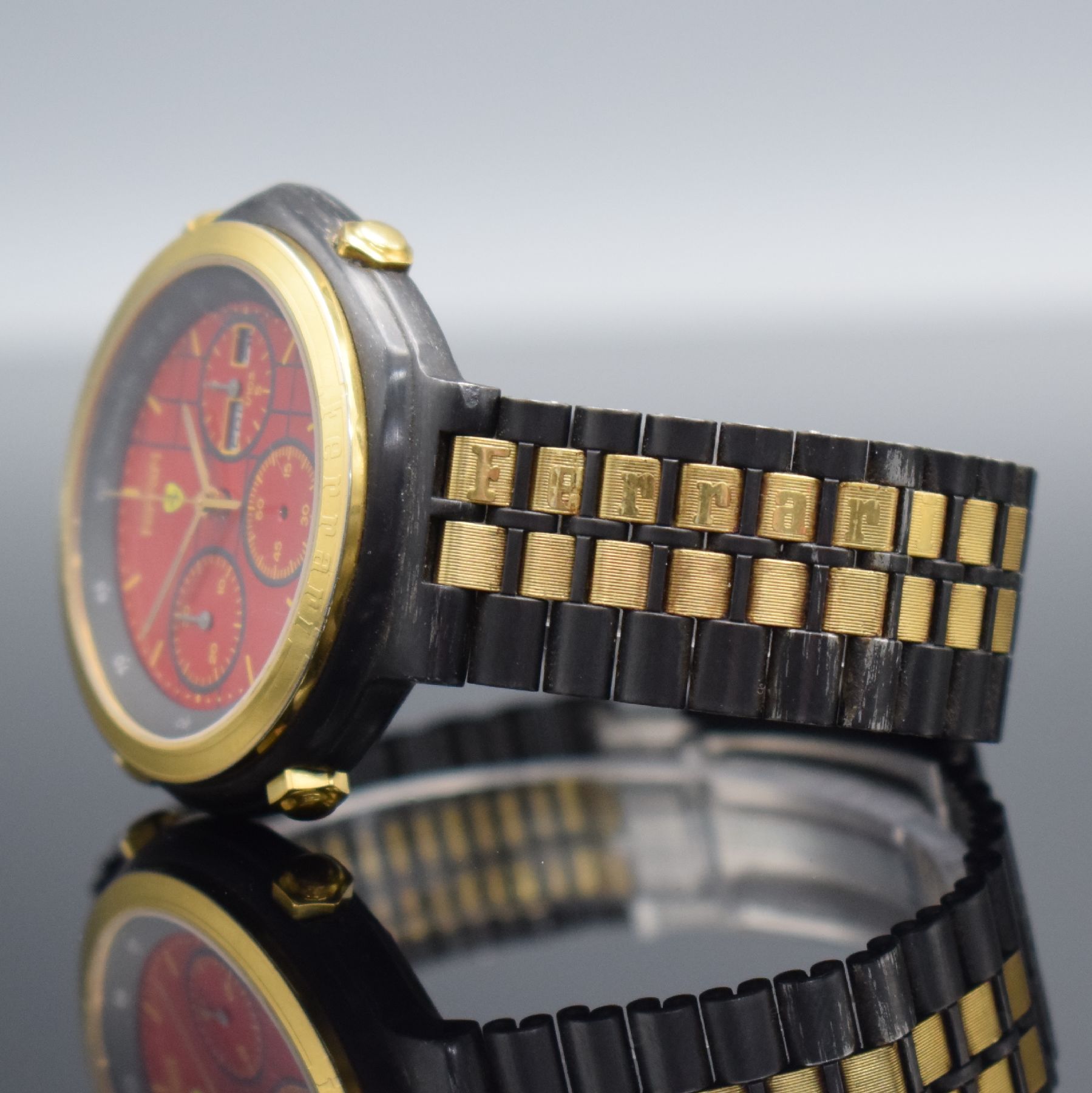 Detail d: FERRARI Formula Herrenchronograph in geschwärztem Stahl, Schweiz um 1990, quarz, Boden verschr., verg. Lünette m. Ferrari- Schriftzug, orig. ...