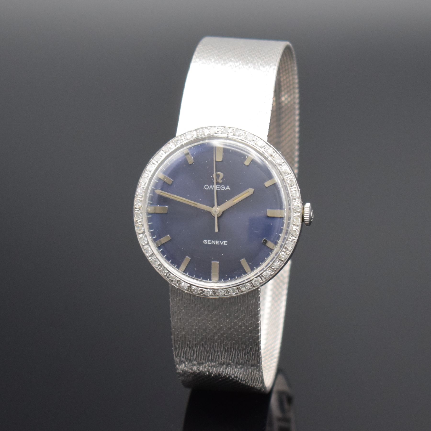 Herrenarmbanduhr in WG 750/000 mit Omega Werk & Diamantbesatz, Schweiz 1960er Jahre, Handaufzug, neutr. Geh. m. neutr. Band, Lünette aufw. m. ...