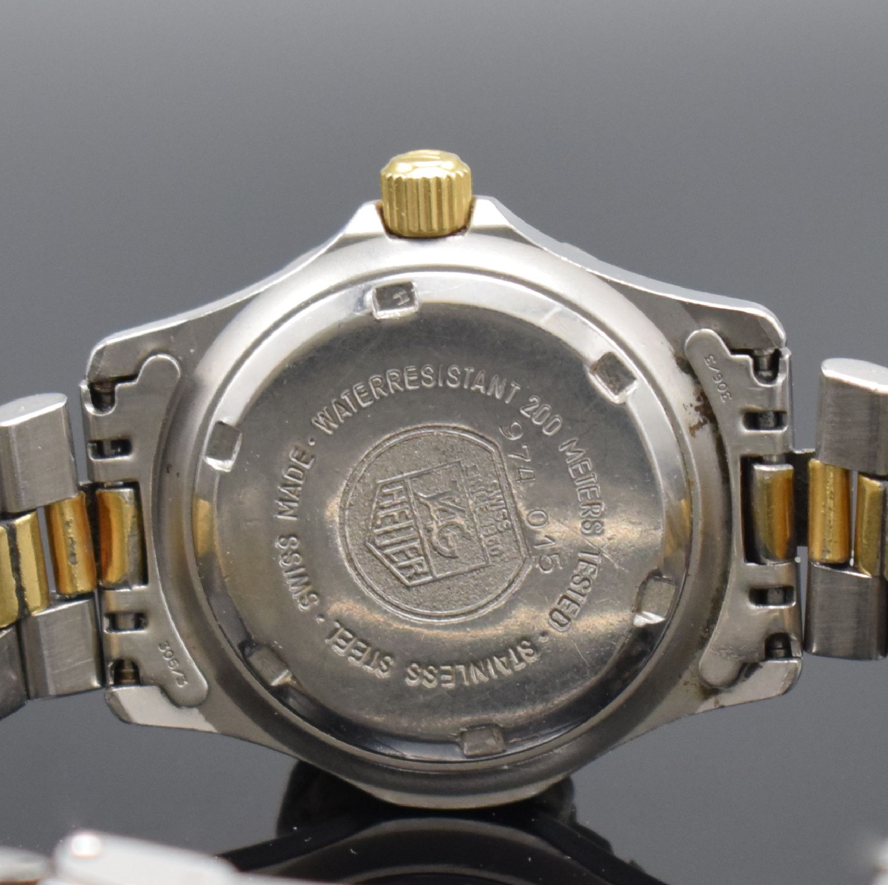Detail e: TAG HEUER Damenarmbanduhr Professional Referenz 974.015, Schweiz um 1980, Edelstahlgeh. inkl. Gliederband m. Faltschl. z. T. verg., Boden & Krone ...