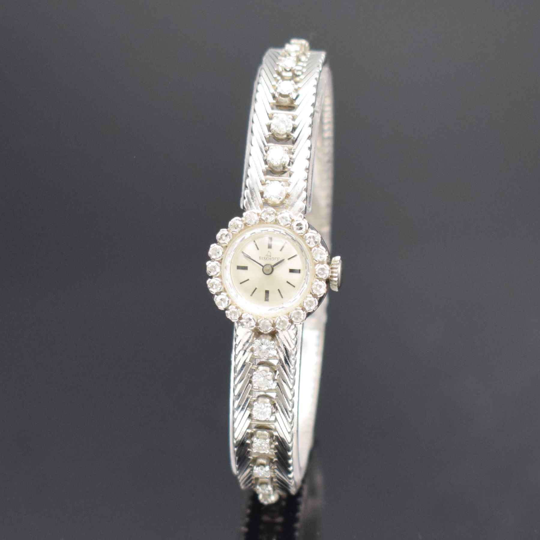 BISCHOFF Damenarmbanduhr in WG 750/000 mit Diamanten, Schweiz um 1965, Handaufzug, Geh. an Goldband in WG 750/000, Boden aufgedr., Lünette & Band m. ...