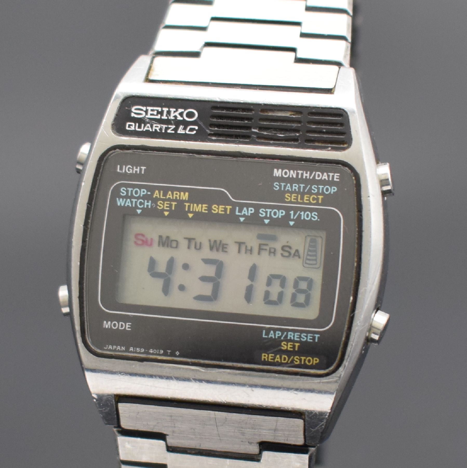 Detail a: SEIKO A159 Alarm Chronograph frühe Armbanduhr mit LCD-Anzeige in Stahl/Stahlband, Japan lt. Rechnungskopie verk. 11/1977, tonneau- förmiges Geh., ...
