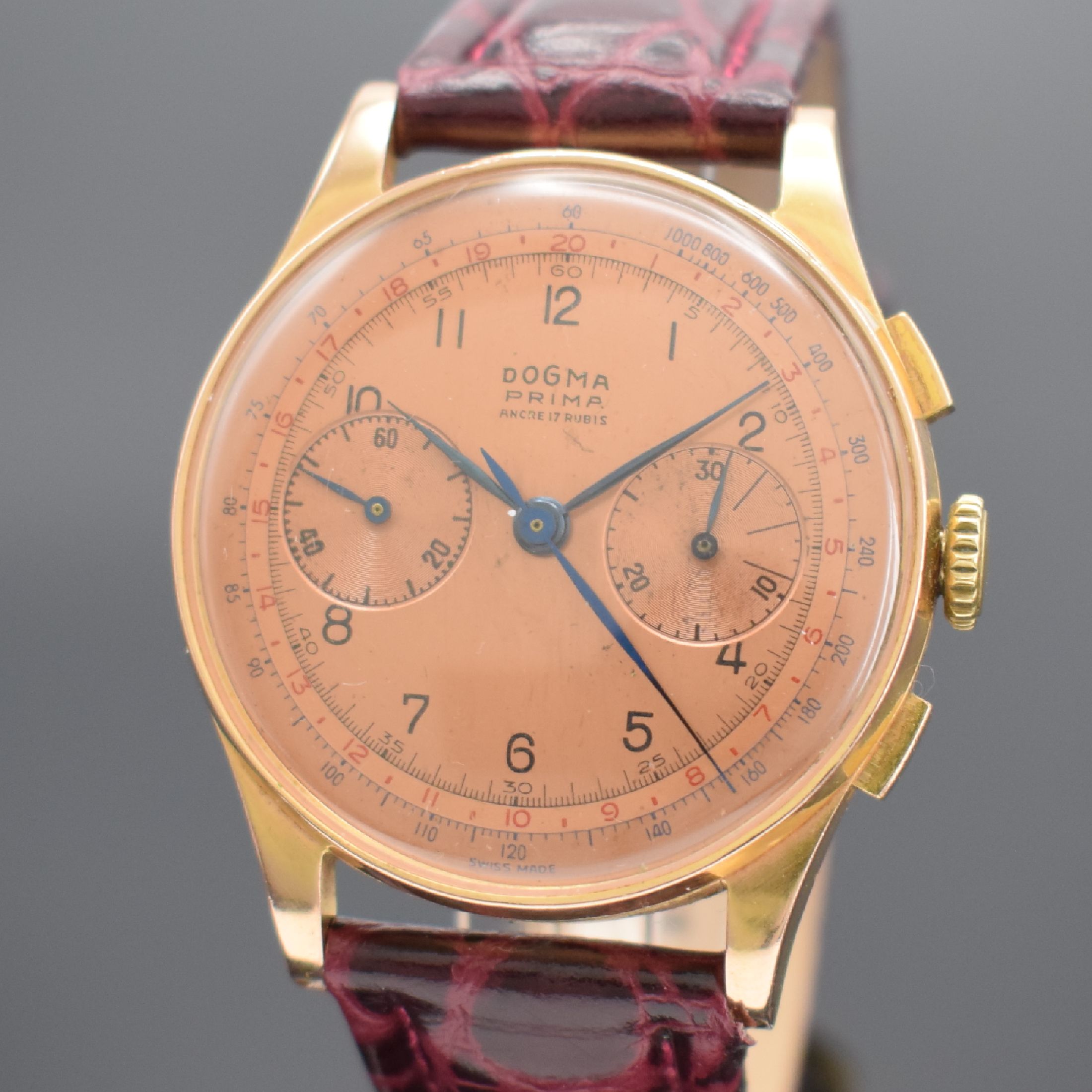 Detail a: DOGMA Prima Herrenchronograph in RoséG 750/000, Schweiz um 1950, Handaufzug, Geh. dell., Boden & Glasrand aufgedr., kupferfarb. Zifferbl. m. arab. ...