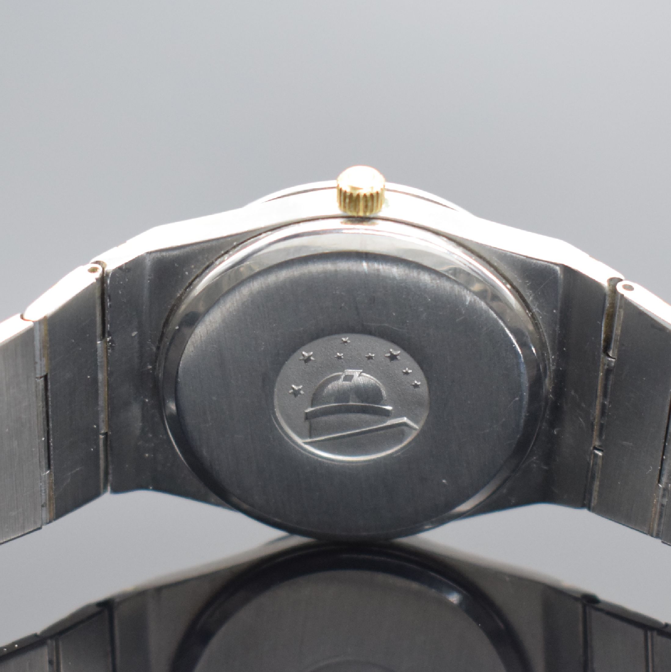 Detail e: OMEGA Constellation Herrenarmbanduhr in Stahl/Gold, Schweiz um 1975, quarz, Ref. 395.0803, Geh. an orig. Gliederband m. Faltschl., Boden m. Darst. ...