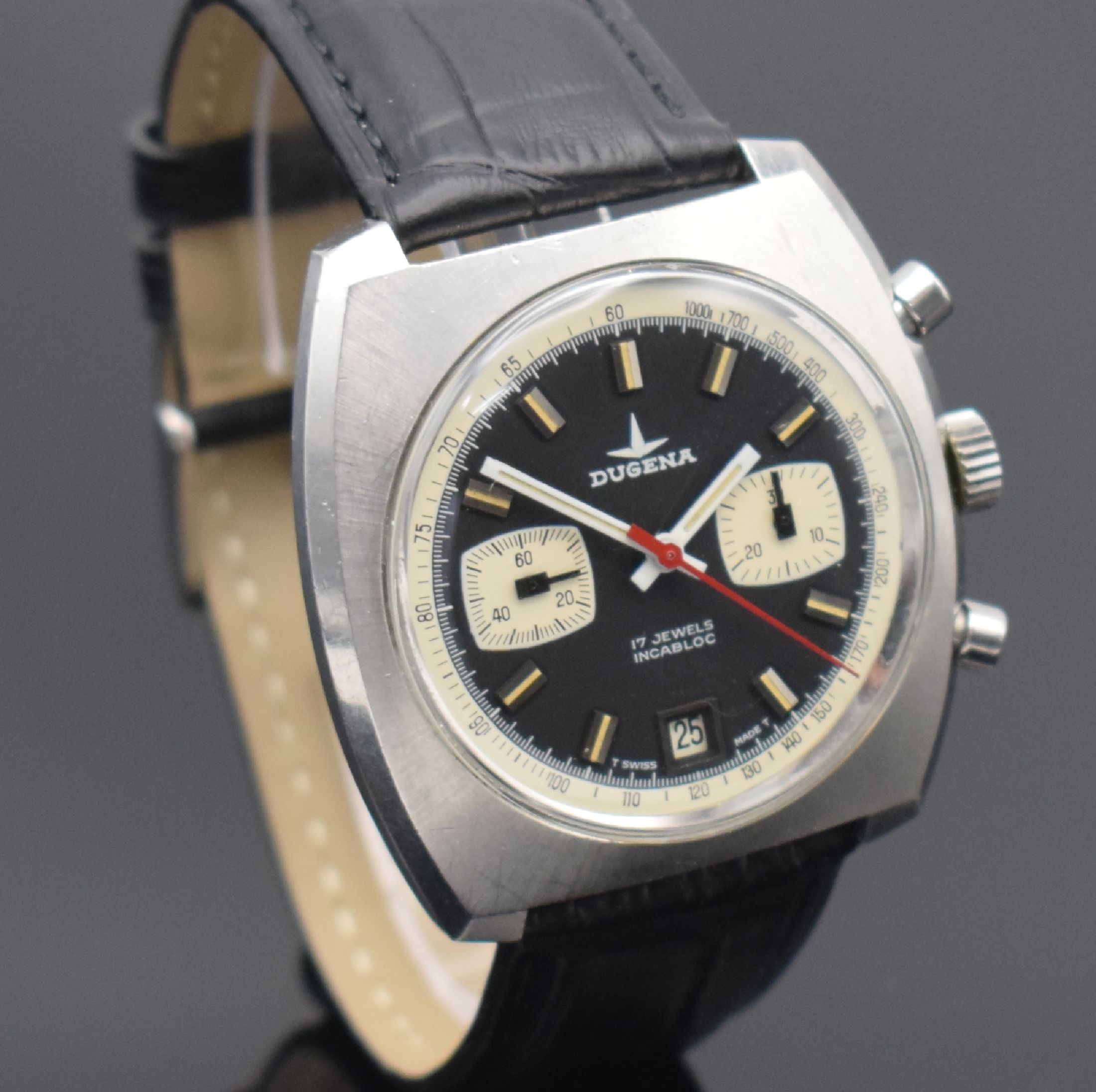 Detail c: DUGENA Herrenchronograph in Stahl, Schweiz um 1970, Handaufzug, unpoliertes verschr. Geh., schwarzes Zifferbl., weiße Hilfsblätter & ...