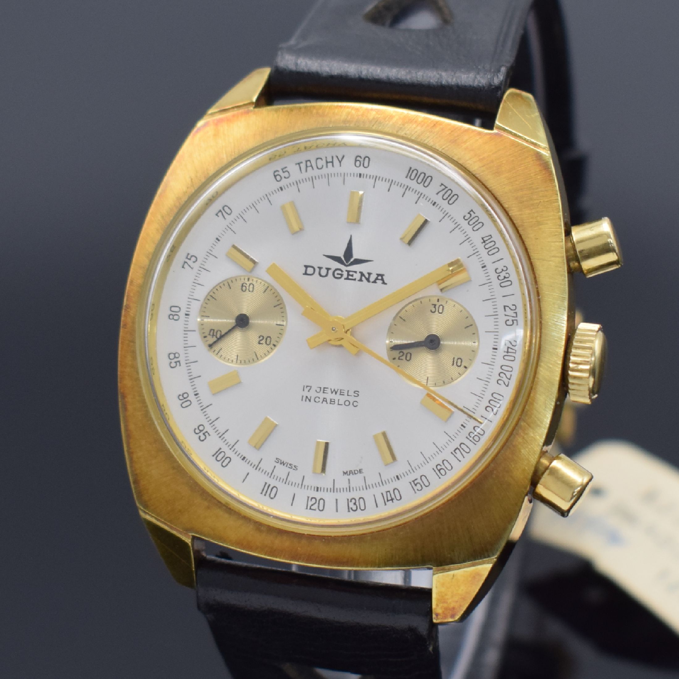 Detail a: DUGENA Herrenarmbanduhr mit Chronograph, Schweiz um 1968, Handaufzug, verg. Gehäuse, Stahlboden geschr., silb. Zifferbl. mit aufges. gold. ...