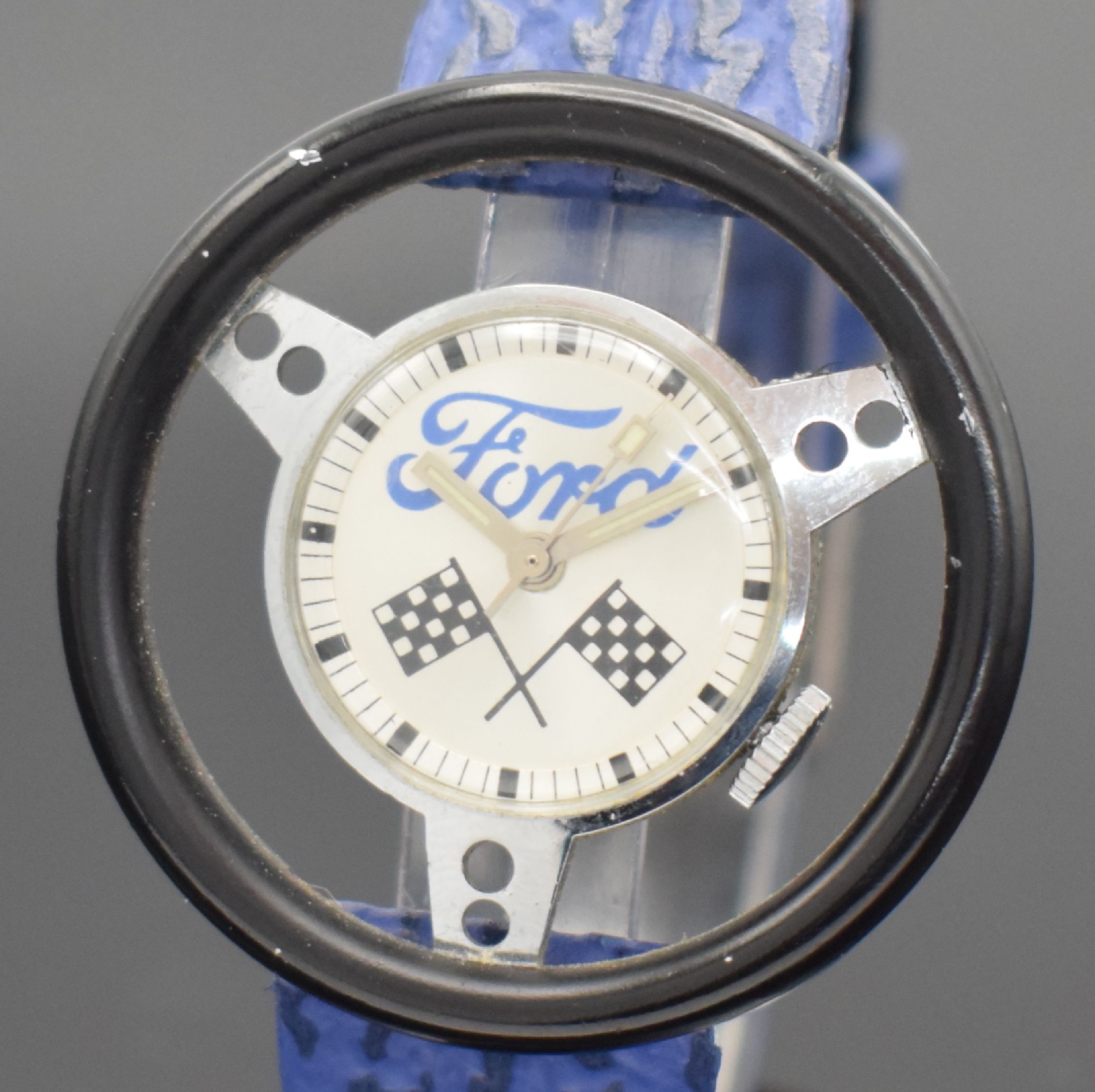 Detail a: Herrenarmbanduhr bezeichnet Ford in Form eines Lenkrads, Schweiz um 1965, verchr. stilisiertes Gehäuse, silb. Zifferblatt entspr. sign. & mit ...