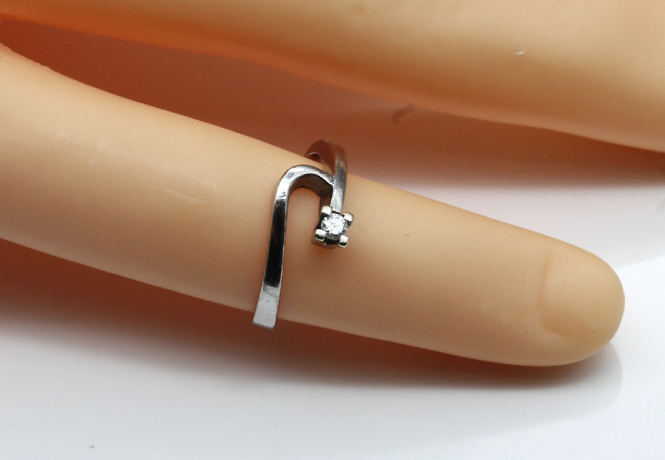 Detail a: 14 kt Gold Ring mit Brillant, WG 585/000, geschwungene Ringschiene, Ende bes. mit einem Brillanten ca. 0.05 ct Weiß/vs, RW 49.5, ca. 2.3 g, mit ...