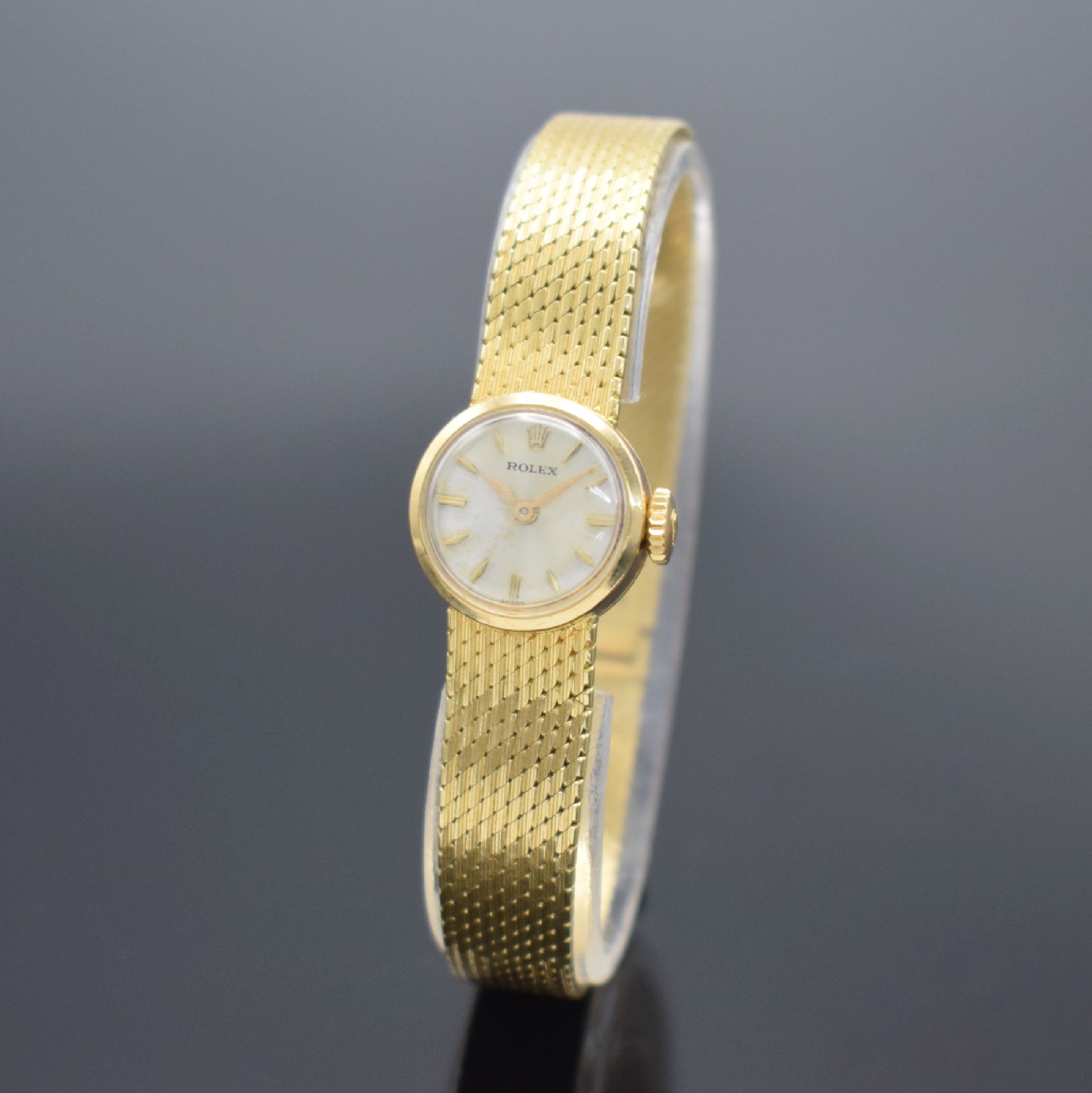 ROLEX Damengoldbanduhr in GG 750/000, Schweiz um 1950, Handaufzug, Geh. an neutr. Goldband in GG 750/000, Boden aufgedr., silb. Zifferbl. m. gold. ...