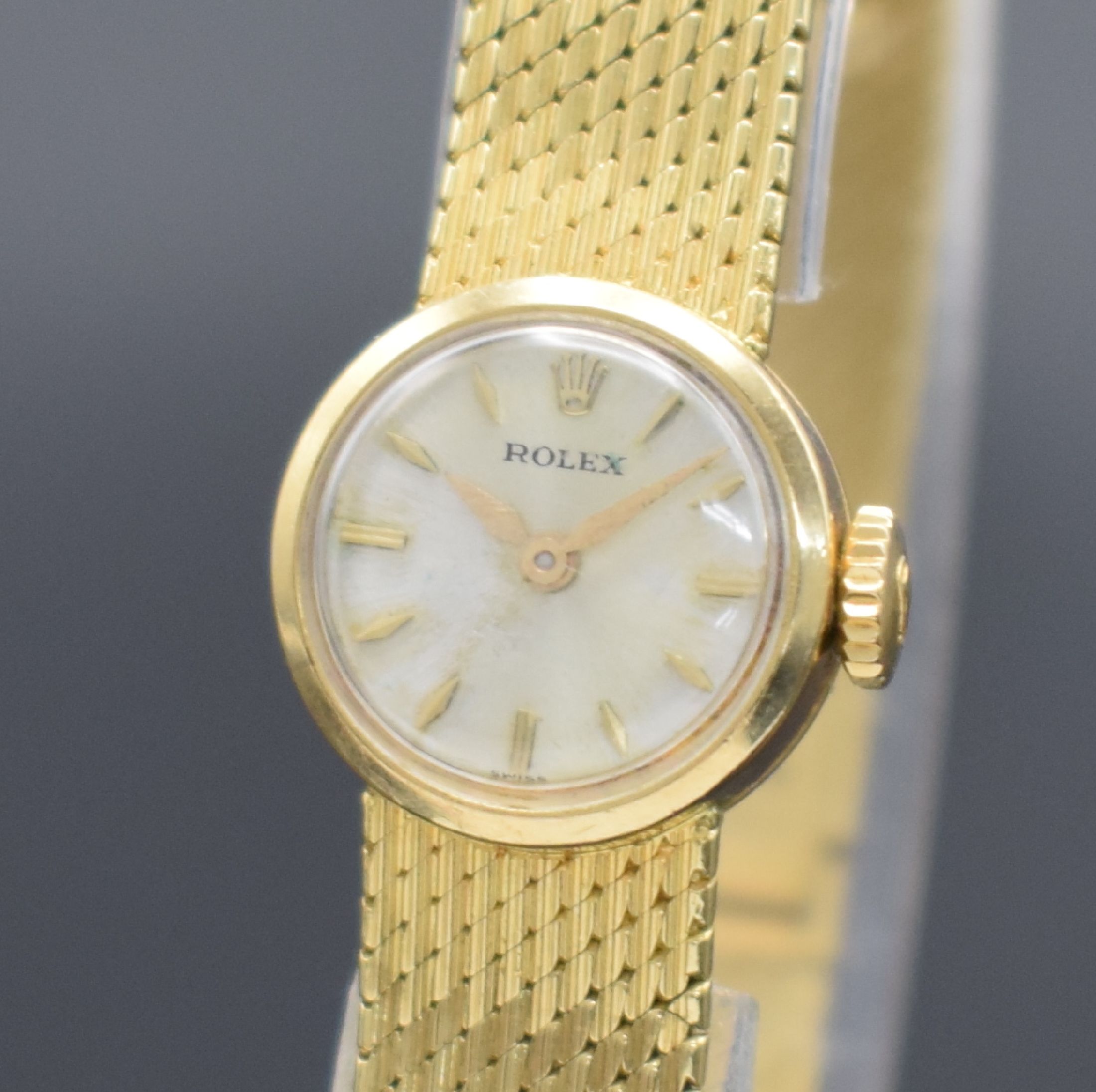 Detail a: ROLEX Damengoldbanduhr in GG 750/000, Schweiz um 1950, Handaufzug, Geh. an neutr. Goldband in GG 750/000, Boden aufgedr., silb. Zifferbl. m. gold. ...