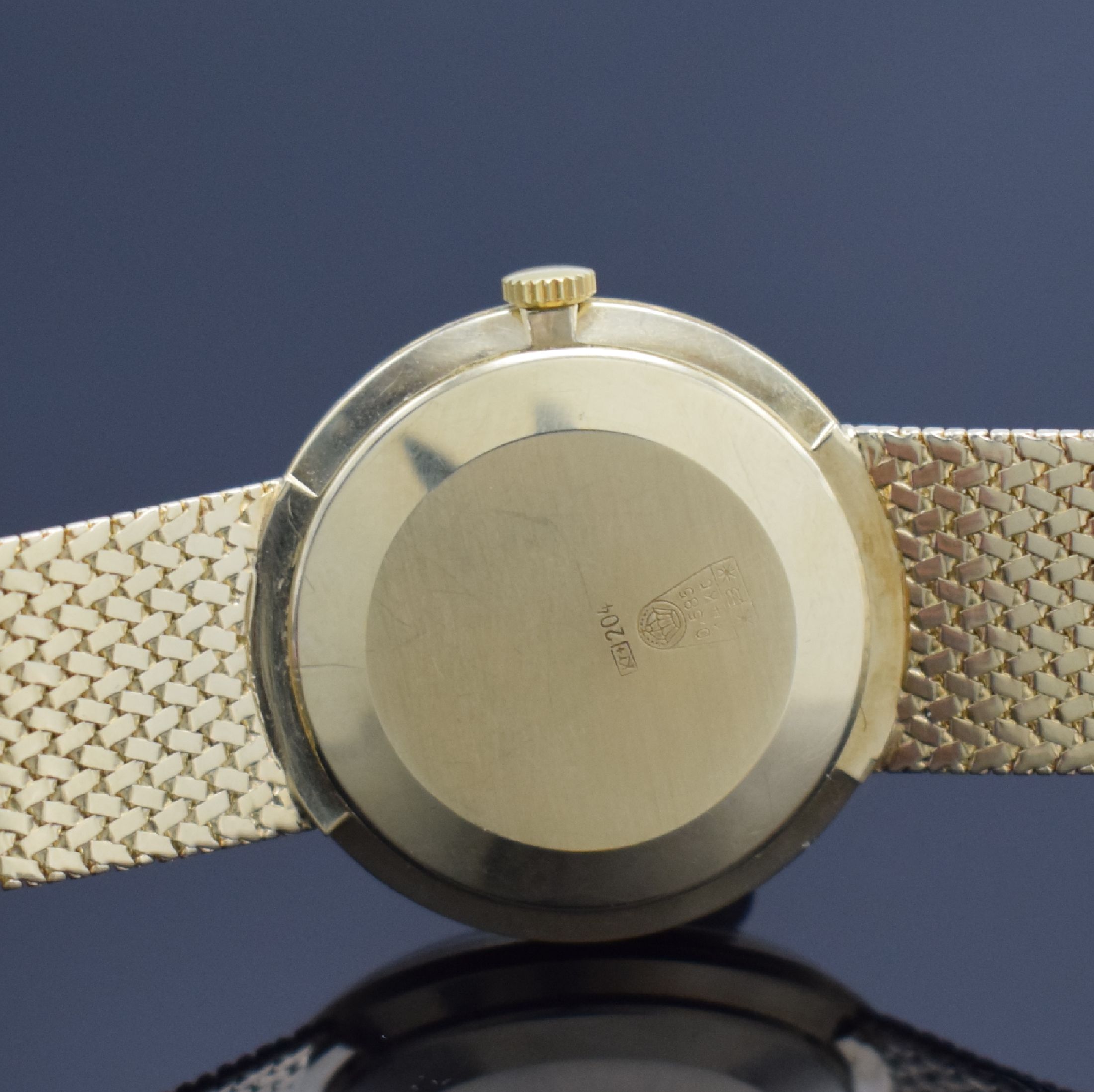Detail d: DUGENA Herrengoldbanduhr in GG 585/000, Schweiz um 1960, Handaufzug, Geh. an neutr. Goldband in GG 585/000, Boden & Glasrand aufgedr., silb. ...