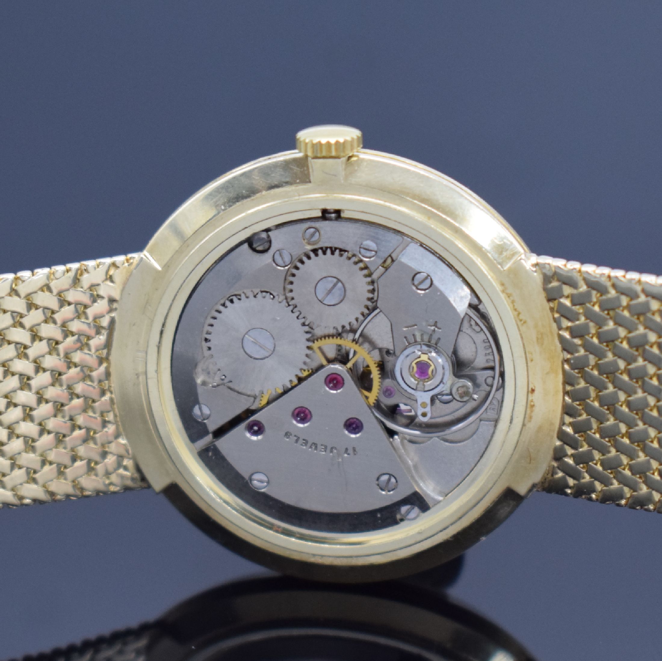 Detail e: DUGENA Herrengoldbanduhr in GG 585/000, Schweiz um 1960, Handaufzug, Geh. an neutr. Goldband in GG 585/000, Boden & Glasrand aufgedr., silb. ...